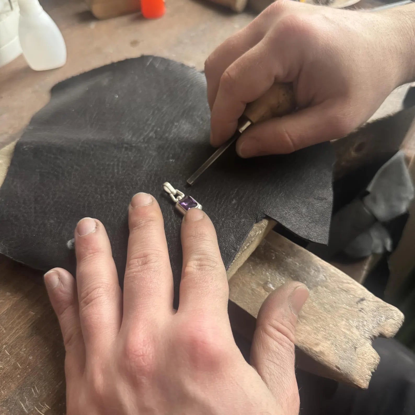 Artistic studio photograph of a luxury amethyst pendant necklace on a silver chain, emphasizing modern minimalist design, rich purple gemstone color, and high-end craftsmanship