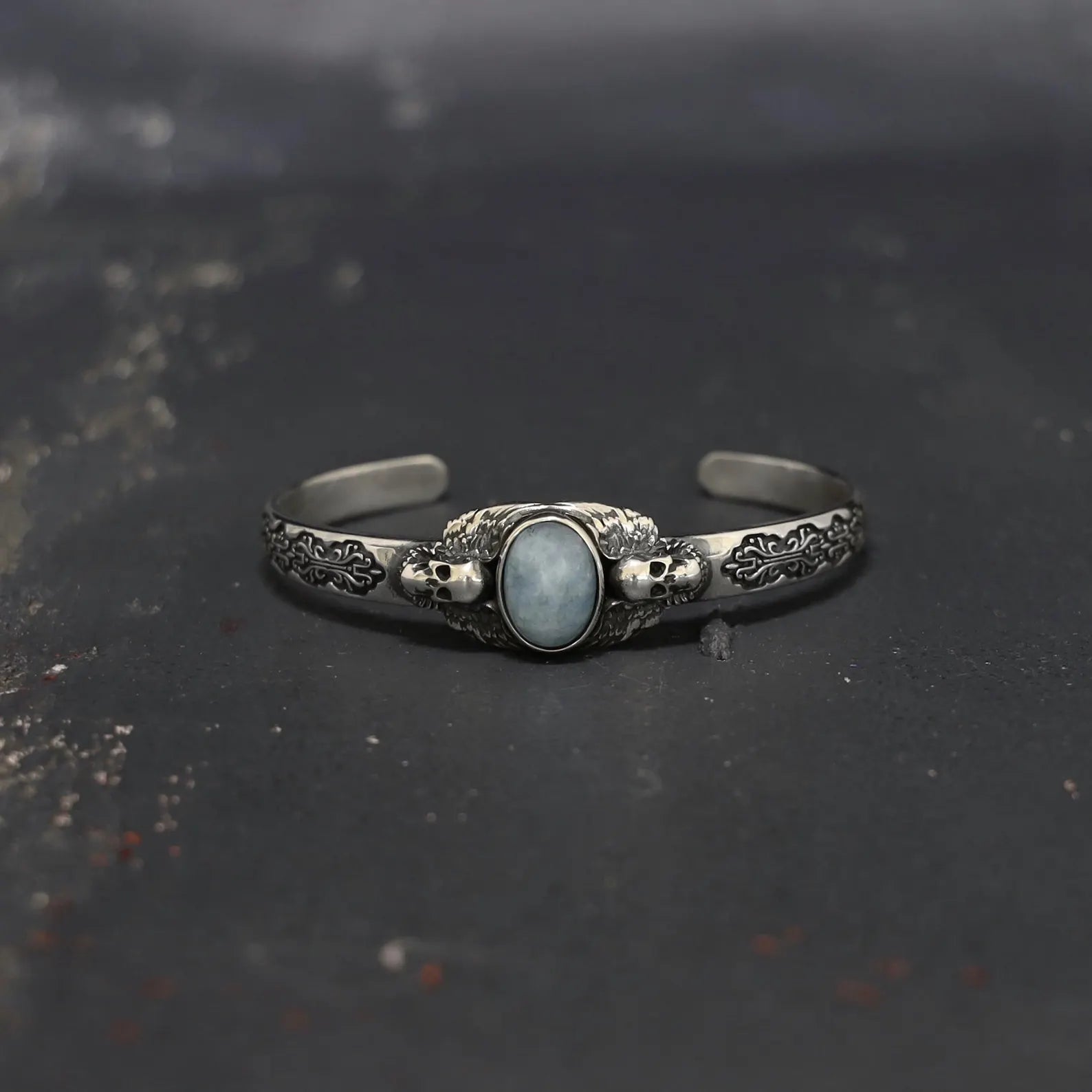 Close-up of the intricate skull detail on this sterling silver aquamarine bracelet, showcasing the precise handcrafted artistry and the natural beauty of the aquamarine stone. This bracelet is perfect for those who embrace gothic and alternative style, offering a one-of-a-kind accessory that merges the dark elegance of the skull motif with the calming spiritual energy of aquamarine, making it a powerful and stylish statement piece.