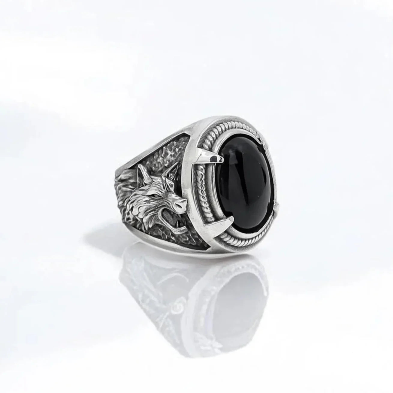 Handcrafted sterling silver wolf ring featuring a polished black onyx gemstone set into a highly detailed band. The design showcases intricate wolf symbolism, representing strength, protection, and primal energy. This statement piece blends Viking inspiration with gothic elegance, making it a powerful talisman for those who value loyalty, courage, and deep-rooted meaning in their jewelry.