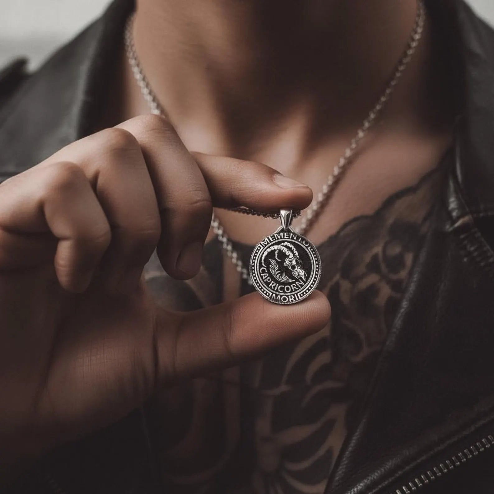Capricorn Sea-Goat pendant worn on a male model, showcasing a bold gothic astrology necklace with mystical symbolism and handcrafted sterling silver finish