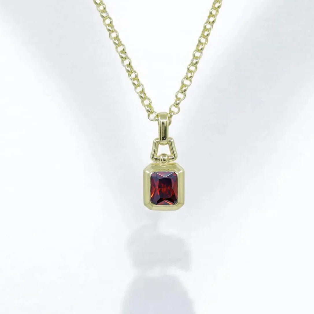 Gold plated lab ruby necklace featuring an emerald cut gemstone set in sterling silver, this handcrafted pendant is the perfect blend of elegance and luxury for men and women alike. A unique ruby birthstone necklace ideal for gifting on birthdays, anniversaries, or special occasions.