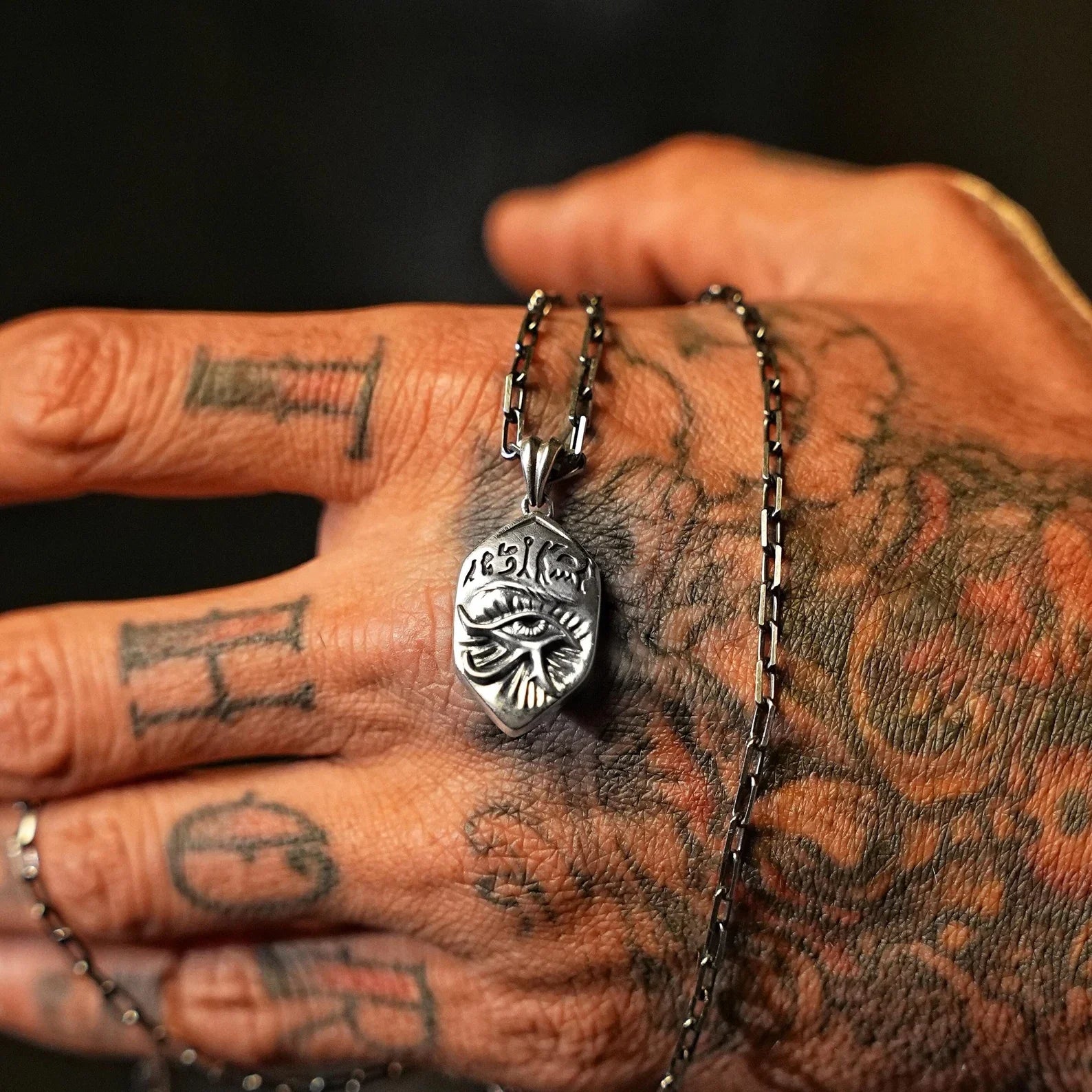 Unique angle of this handcrafted sterling silver Horus Eye pendant, combining ancient Egyptian mythology and modern alternative fashion. Perfect for men and women seeking spiritual protection and style, this necklace is a one-of-a-kind piece that speaks to those who value symbolism and history in their accessories.