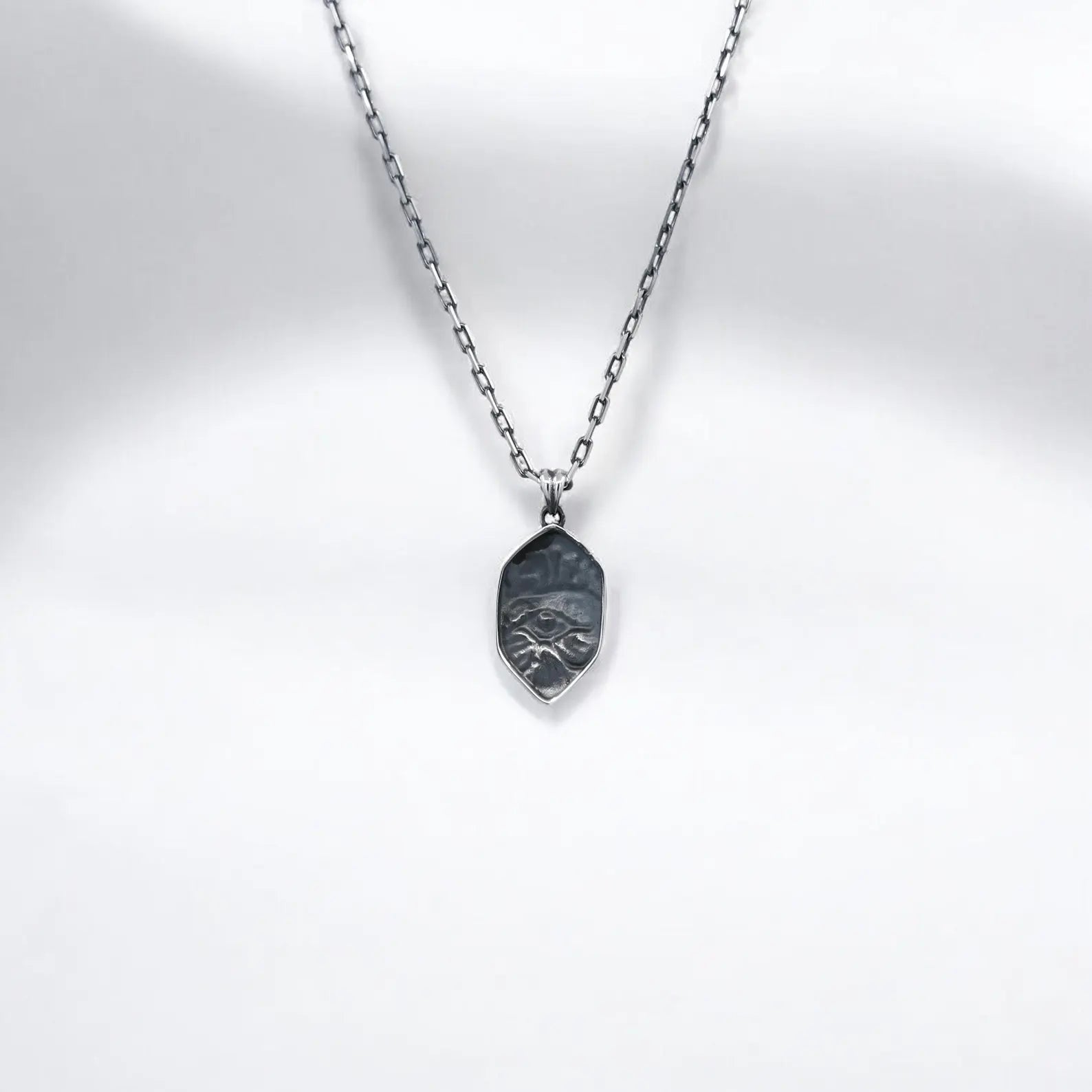 Close-up of a silver Horus Eye pendant necklace, showcasing fine craftsmanship and mythological symbolism. Designed to offer protection and attract positive energy, this Egyptian-inspired talisman is a thoughtful gift for loved ones and a versatile accessory for fans of ancient lore, gothic style, or spiritual fashion.