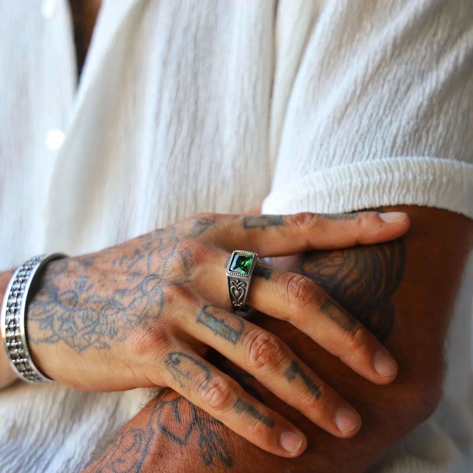 Sterling silver ring for men with a square emerald gemstone centerpiece, designed in a gothic vintage style. Handmade with detailed side engravings and antique oxidized finish, this ring makes a bold fashion statement and is an ideal gift for those who appreciate dark, elegant aesthetics.