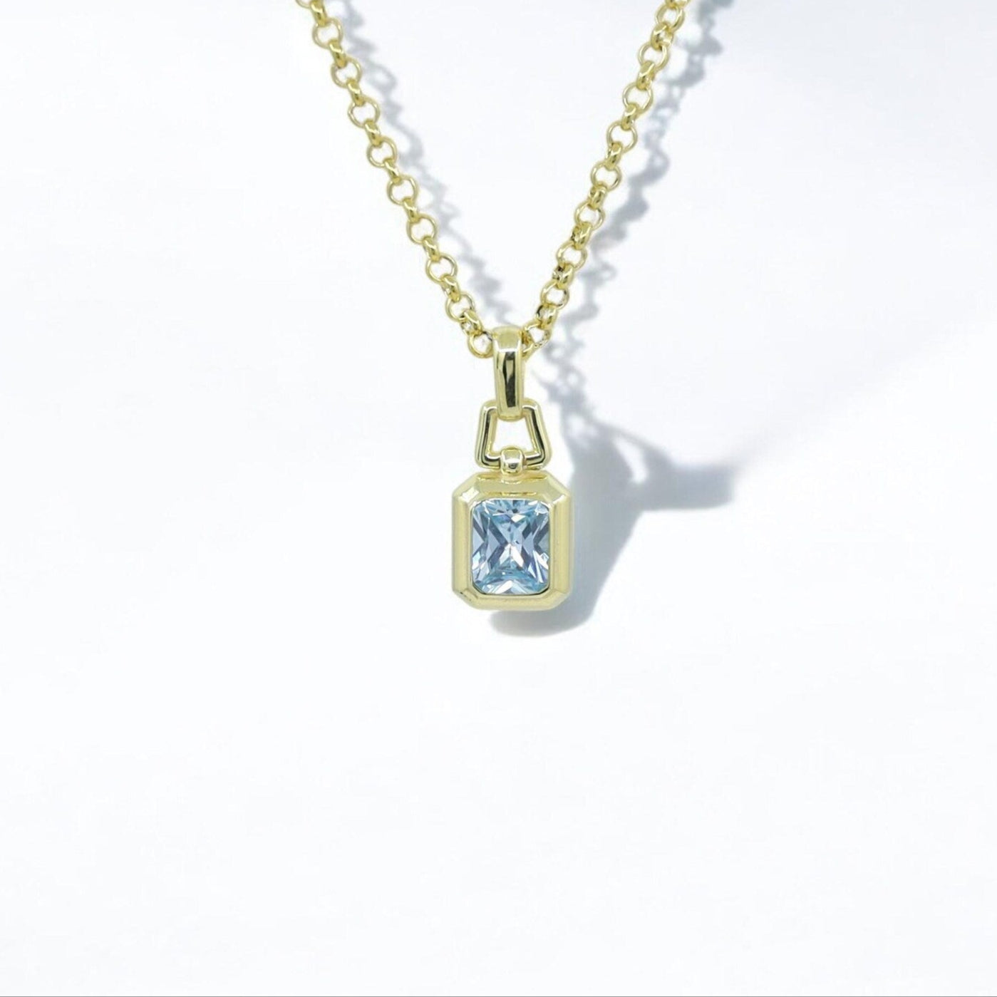Discover timeless elegance with this 14K gold plated aquamarine necklace. Featuring a radiant emerald-cut blue stone, this minimalist pendant reflects the serene beauty of the ocean. A perfect gift for March birthdays or anyone who values calm, clarity, and courage.