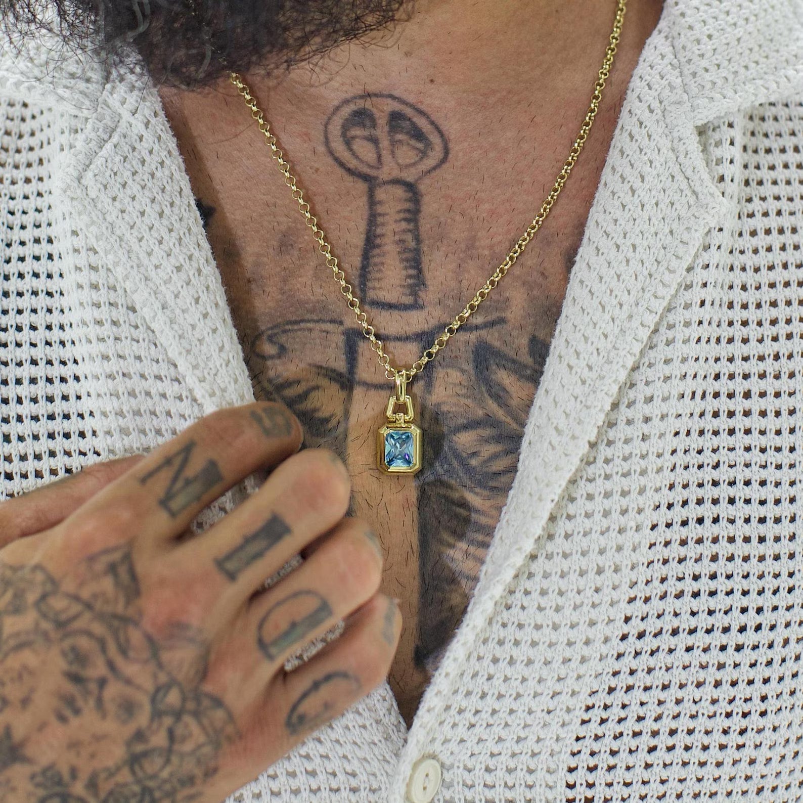 Crafted in sterling silver and finished in rich 14K gold, this aquamarine gemstone necklace exudes modern sophistication. The crisp geometric design and icy blue brilliance make it ideal for men and women seeking subtle luxury with a statement edge.