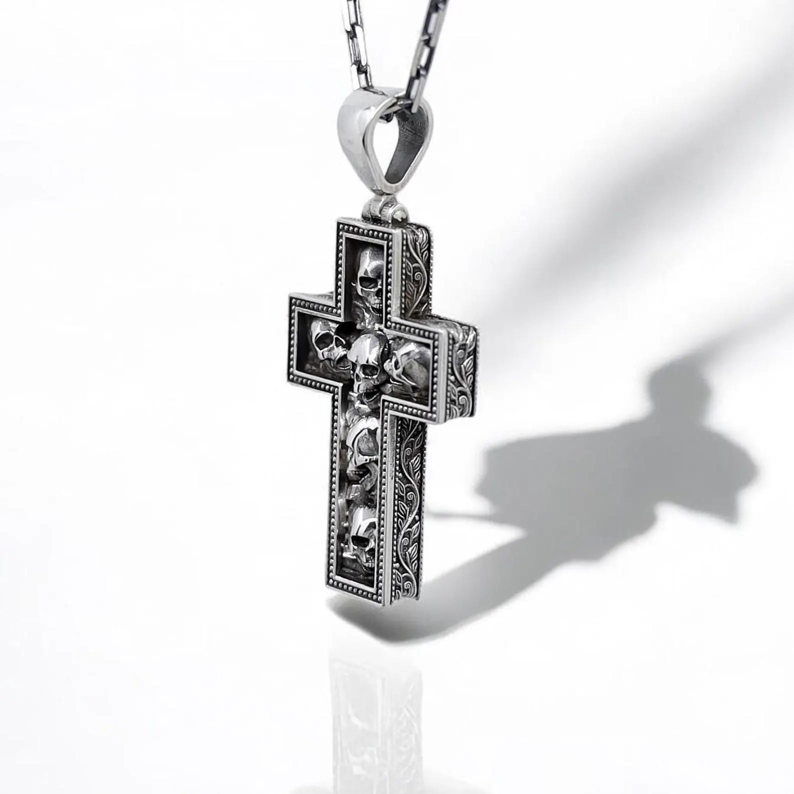 Gothic sterling silver skull cross necklace for men, designed with detailed skull engravings in a bold cross shape. Perfect for biker jewelry lovers, heavy metal fans, and gothic fashion enthusiasts. Durable sterling silver pendant for everyday wear or as a unique gift.