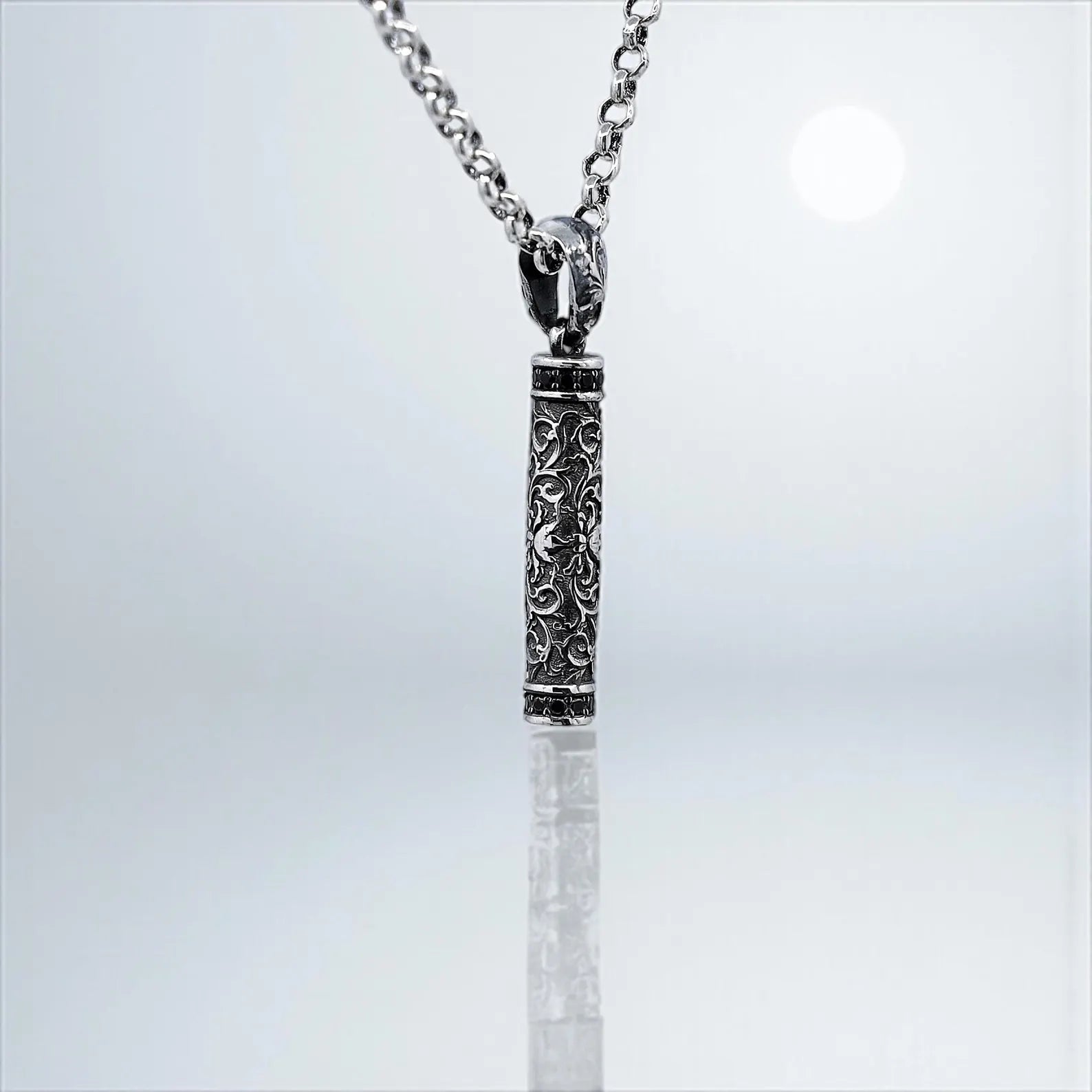 Sterling silver cylinder pendant with detailed floral patterns, offering a perfect blend of antique elegance and gothic fashion. Handcrafted for both men and women, this unique necklace is a meaningful gift idea. Optimized for Shopify gothic jewelry pages and Instagram jewelry showcases.