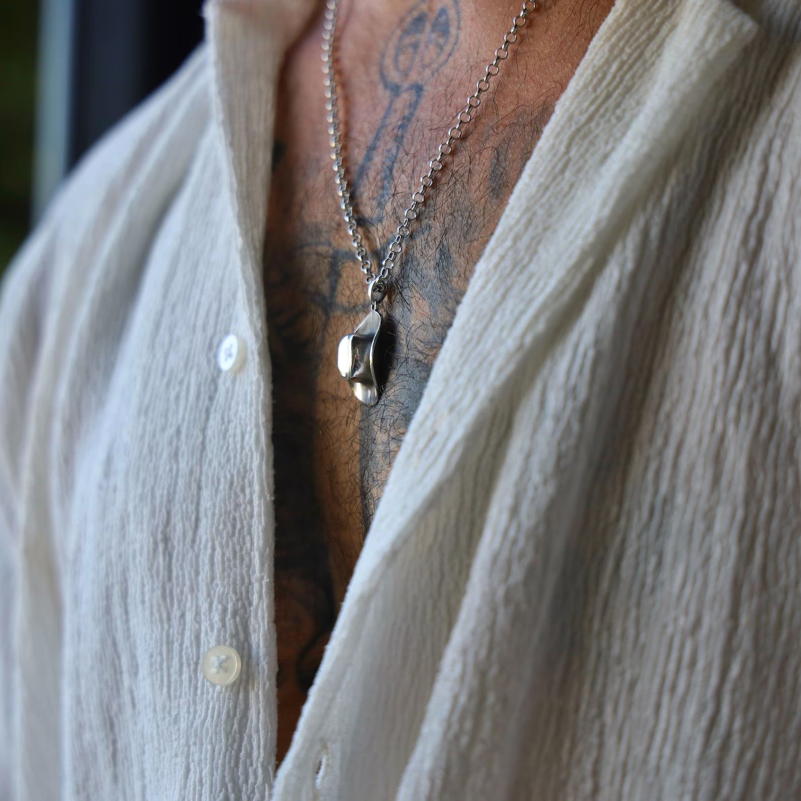 Unique silver pendant necklace inspired by cowboy heritage, featuring a miniature western hat charm, symbolizing freedom, grit, and the spirit of the frontier, perfect for gifting or self-expression.