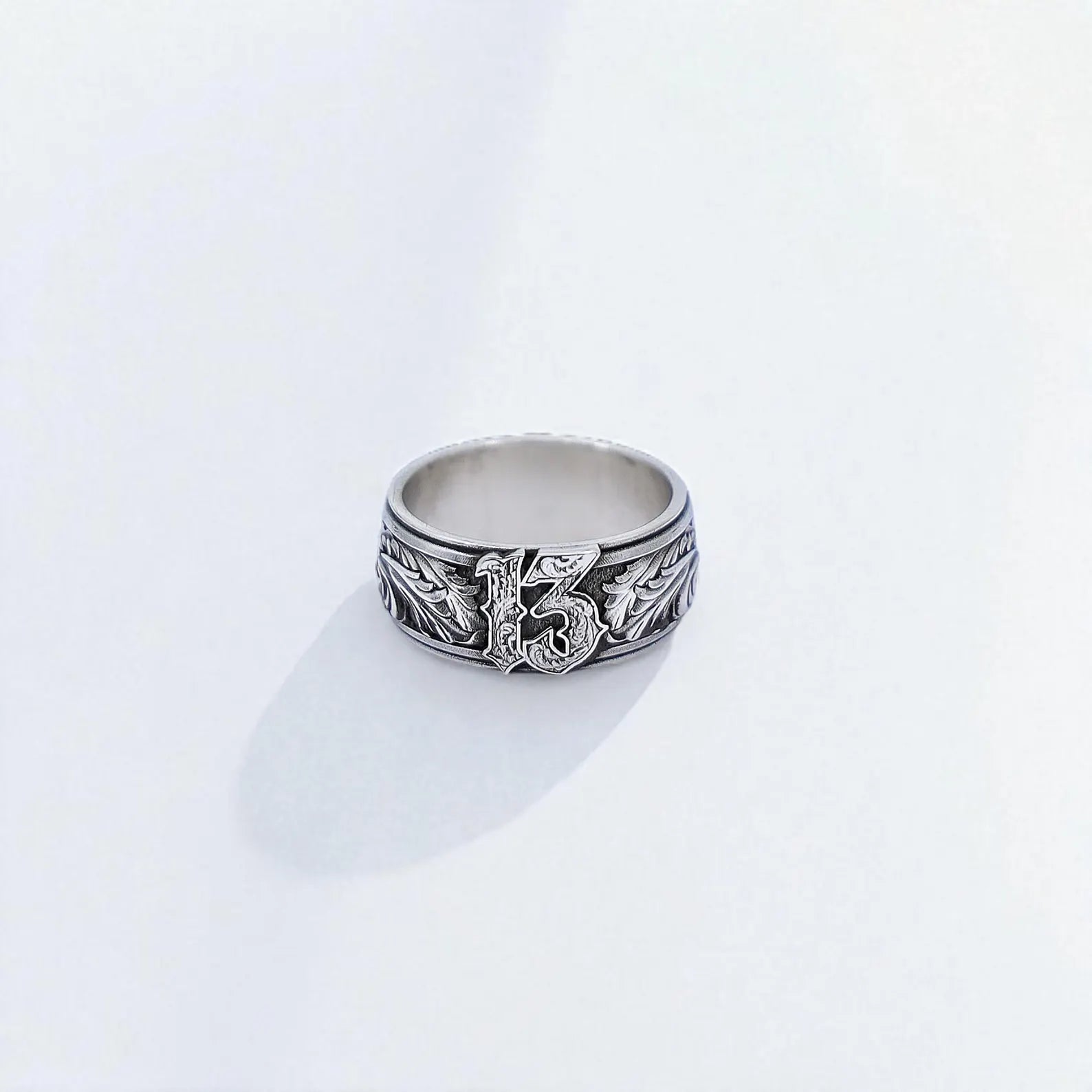 Handcrafted sterling silver Lucky 13 ring for men, featuring bold gothic typography and engraved leaf details. This biker-style band represents rebellion, luck, and individuality—ideal for rockers, tattoo lovers, or anyone with a bold spirit. Made from solid 925 silver with oxidized details for a rugged, timeless finish.