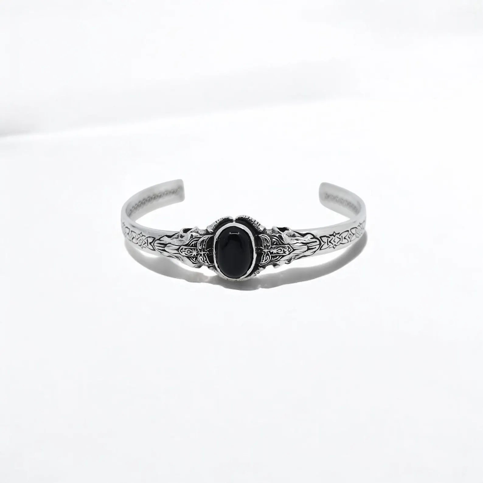 This handcrafted 925 sterling silver cuff bracelet for men features a richly detailed bangle structure with a deep black onyx gemstone. Inspired by ancient warrior styles and Norse mythology, this bold accessory adds timeless strength and character to any outfit.