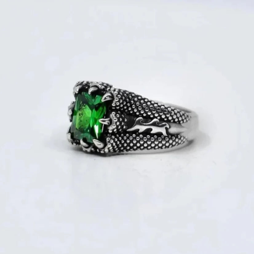 Indulge in the timeless beauty of this handcrafted sterling silver ring featuring an exquisite emerald cut zircon stone. With its modern minimalist band and vibrant green gemstone centerpiece, this birthstone ring for men and women radiates sophistication and luxury, making it a perfect addition to any jewelry collection and a standout piece for both special occasions and everyday wear.