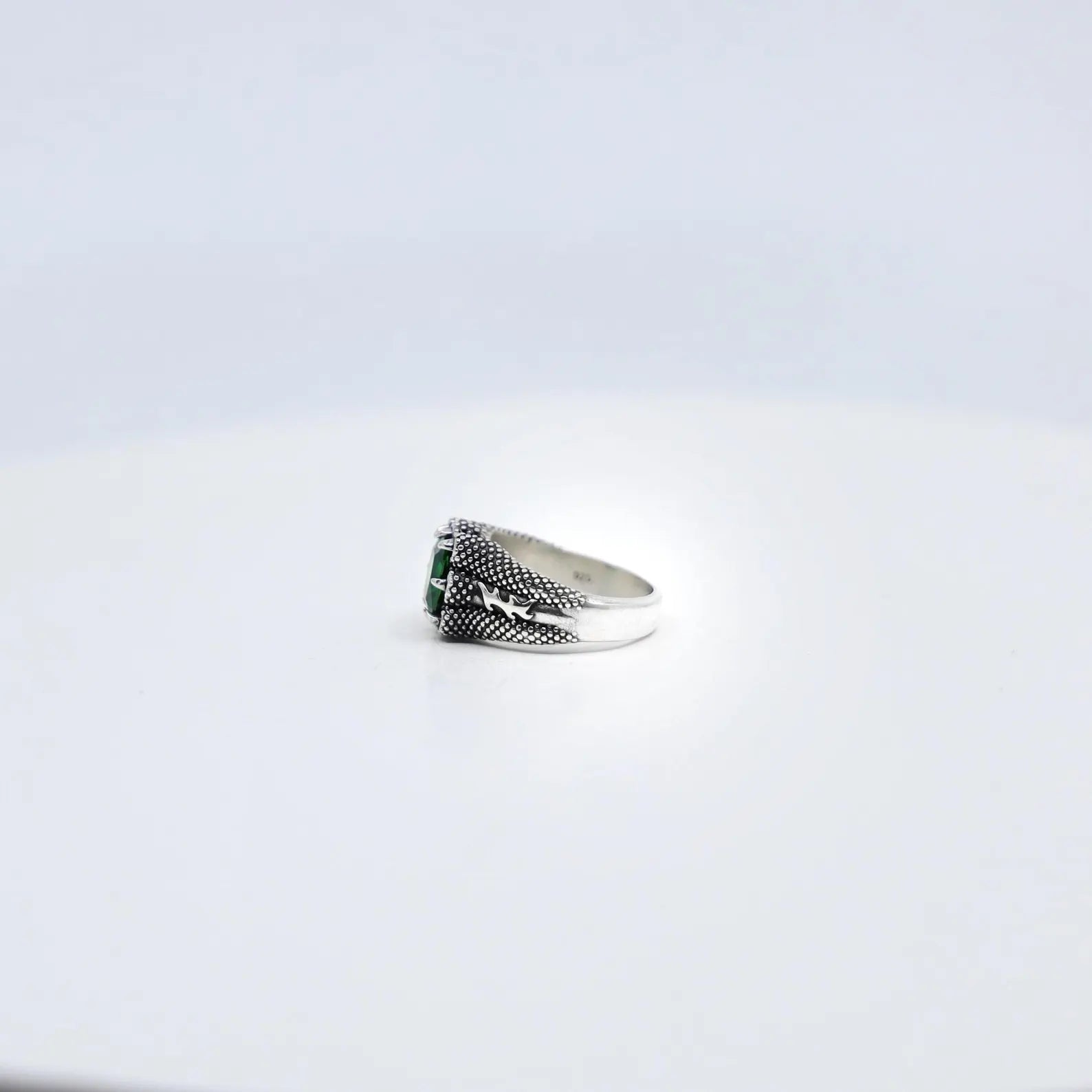 Set against a minimalist white background, this emerald cut zircon ring in sterling silver shines as a classic statement piece. With a weight of 12 grams and a refined 10mm diameter, this ring blends modern minimalist design and birthstone symbolism to create a jewelry piece that speaks to both luxury and personal meaning.