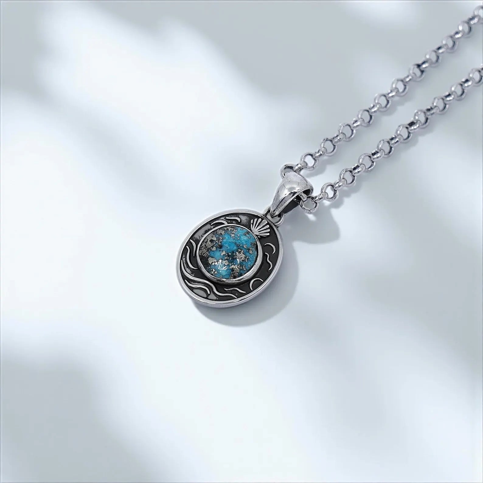 High-quality artisan pendant showcasing a round turquoise stone with unique matrix patterns, set in an oval sterling silver frame inspired by oceanic themes and sailor aesthetics, ideal for sea lovers and spiritual jewelry collectors.