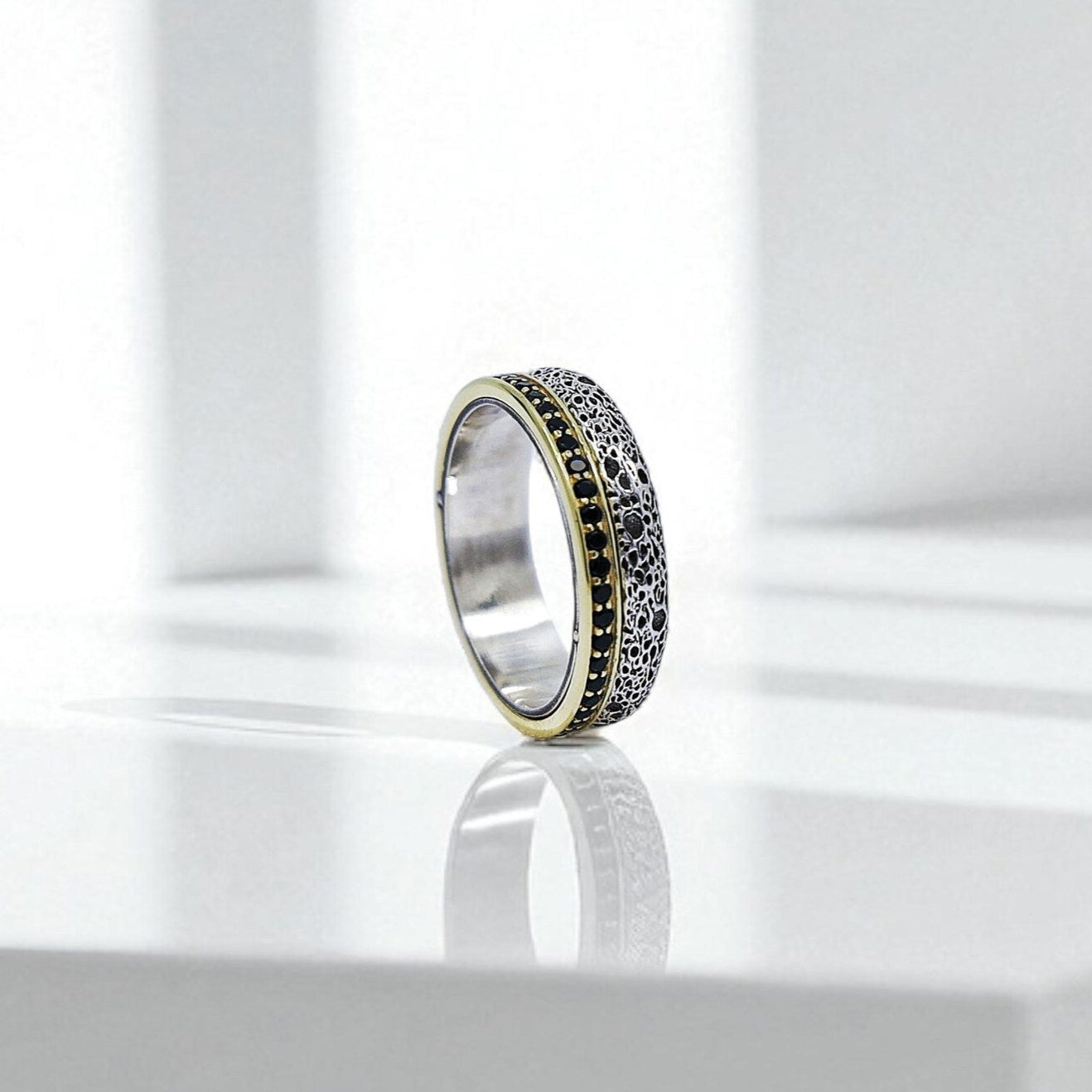 Top-down view highlighting the consistent craftsmanship of the textured silver surface and gold rope-like trim, showing the artisan quality and durability of these couple bands. Ideal for lovers of vintage or alternative wedding styles.