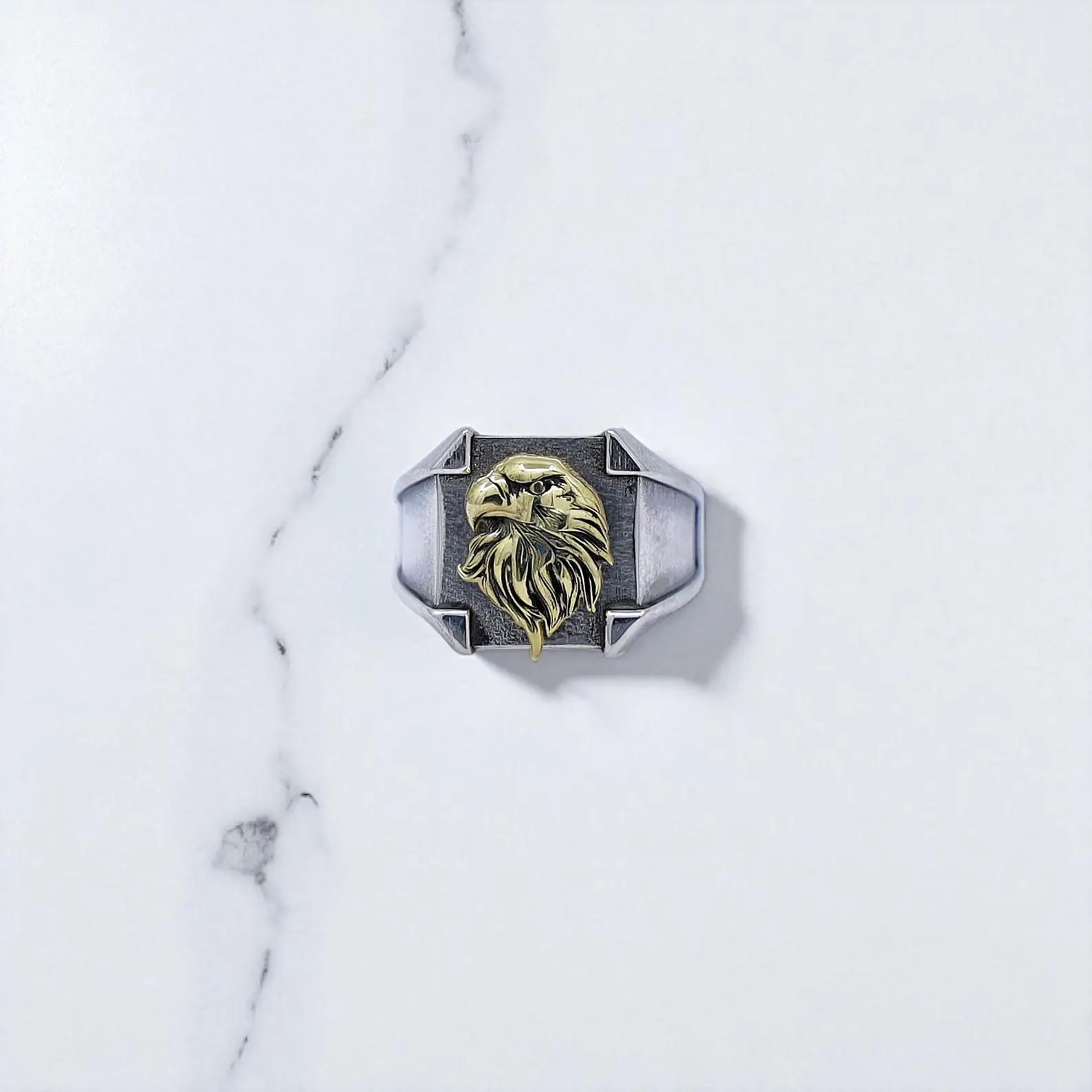 Masculine vintage-style signet ring with a brushed sterling silver band and elevated golden eagle head motif, meticulously crafted to reflect timeless American heritage and strong individuality — ideal as a pinky ring for bold men.