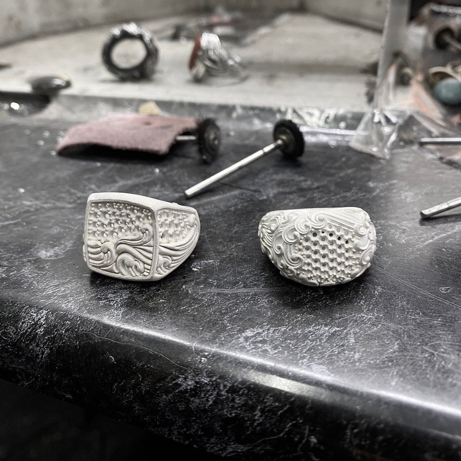 Artistic overhead view of the ruby wave ring laid flat under natural light, enhancing the brilliance of the stone and the sculpted sea pattern. Perfect for Etsy searches related to personalized men’s rings, handcrafted ocean jewelry, or one-of-a-kind ruby statement gifts.