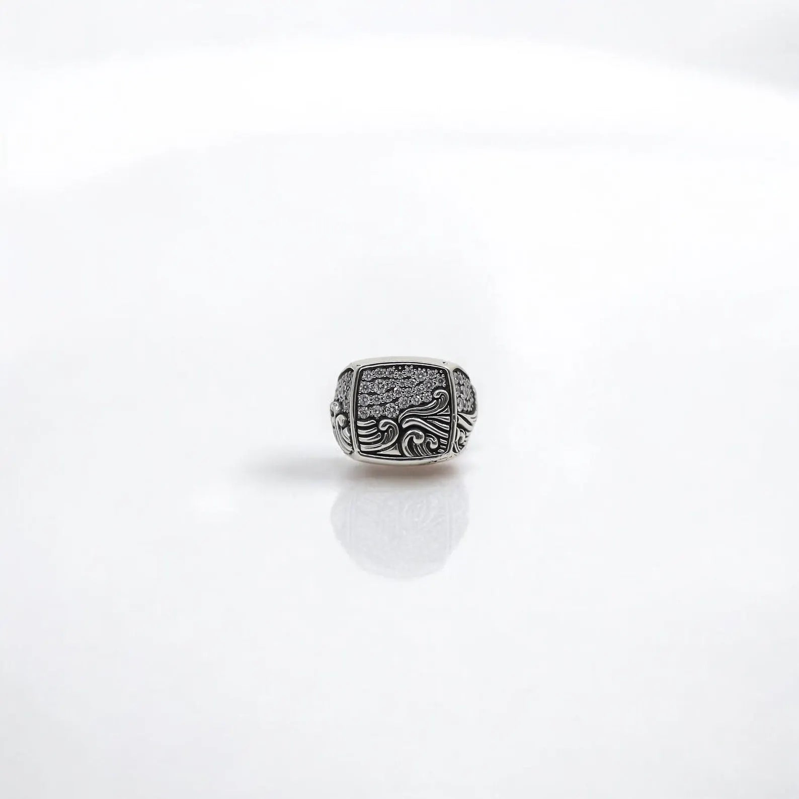 This elegant nautical ring is a wearable tribute to the ocean's strength and serenity. Handcrafted in 925 sterling silver and polished to perfection, the ring is detailed with sculpted wave motifs that flow into a bed of shimmering zircon stones. Perfect for everyday wear or special occasions, this maritime ring makes a sophisticated and thoughtful gift for men who appreciate symbolism, craftsmanship, and timeless design.