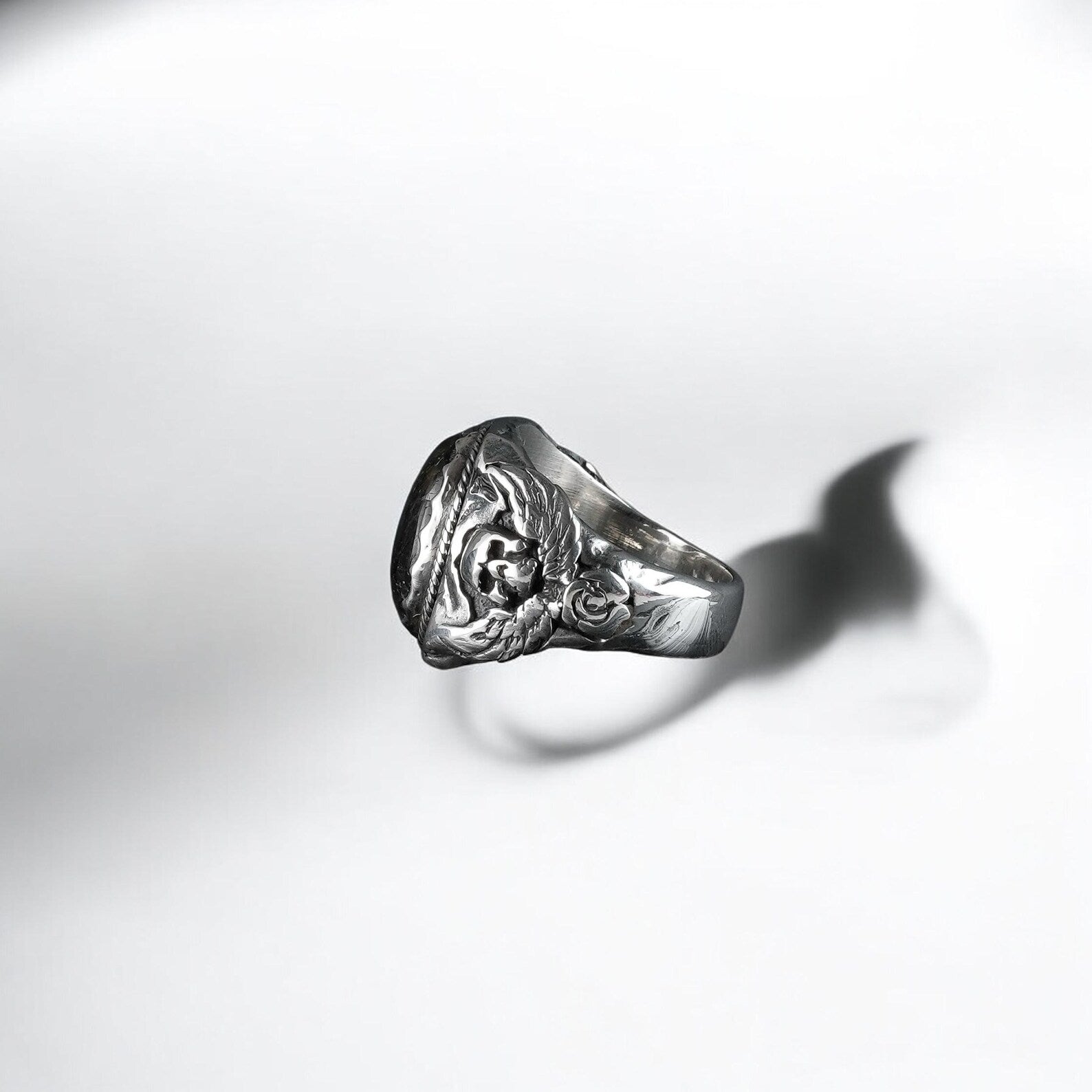 A dramatic gothic-style labradorite ring made from sterling silver and featuring winged skull figures on each side. This spiritual yet rebellious piece offers a strong visual presence and meaningful energy, ideal for those who appreciate mystical symbolism and artisan quality.