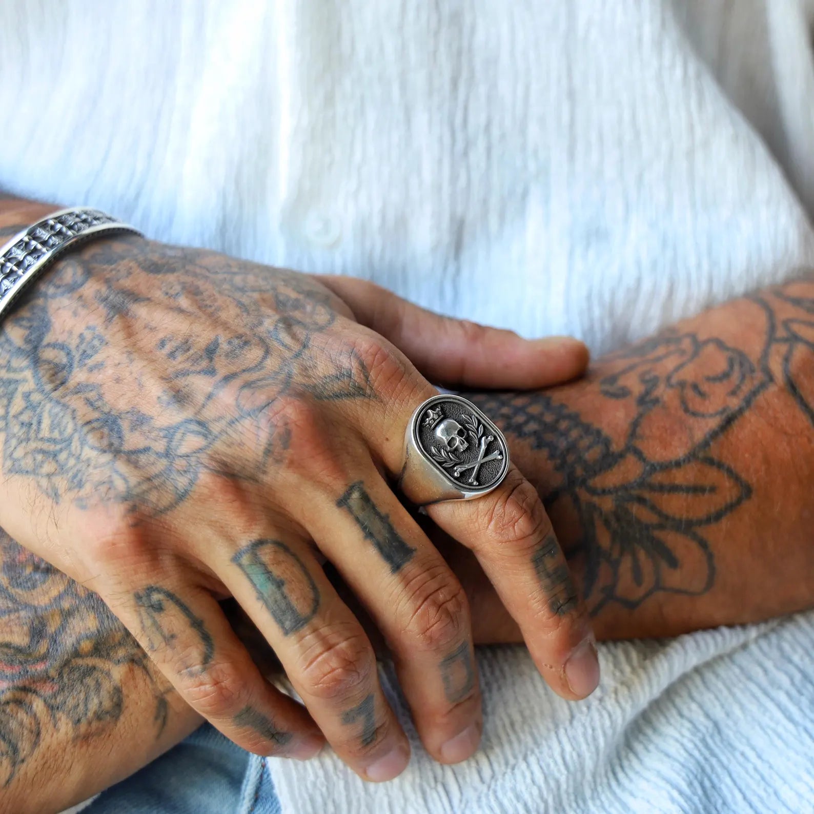 Handcrafted skull signet ring for men made from solid 925 sterling silver, designed with gothic crossbone motifs and a royal crown above the skull, symbolizing rebellion, strength, and timeless masculine elegance.