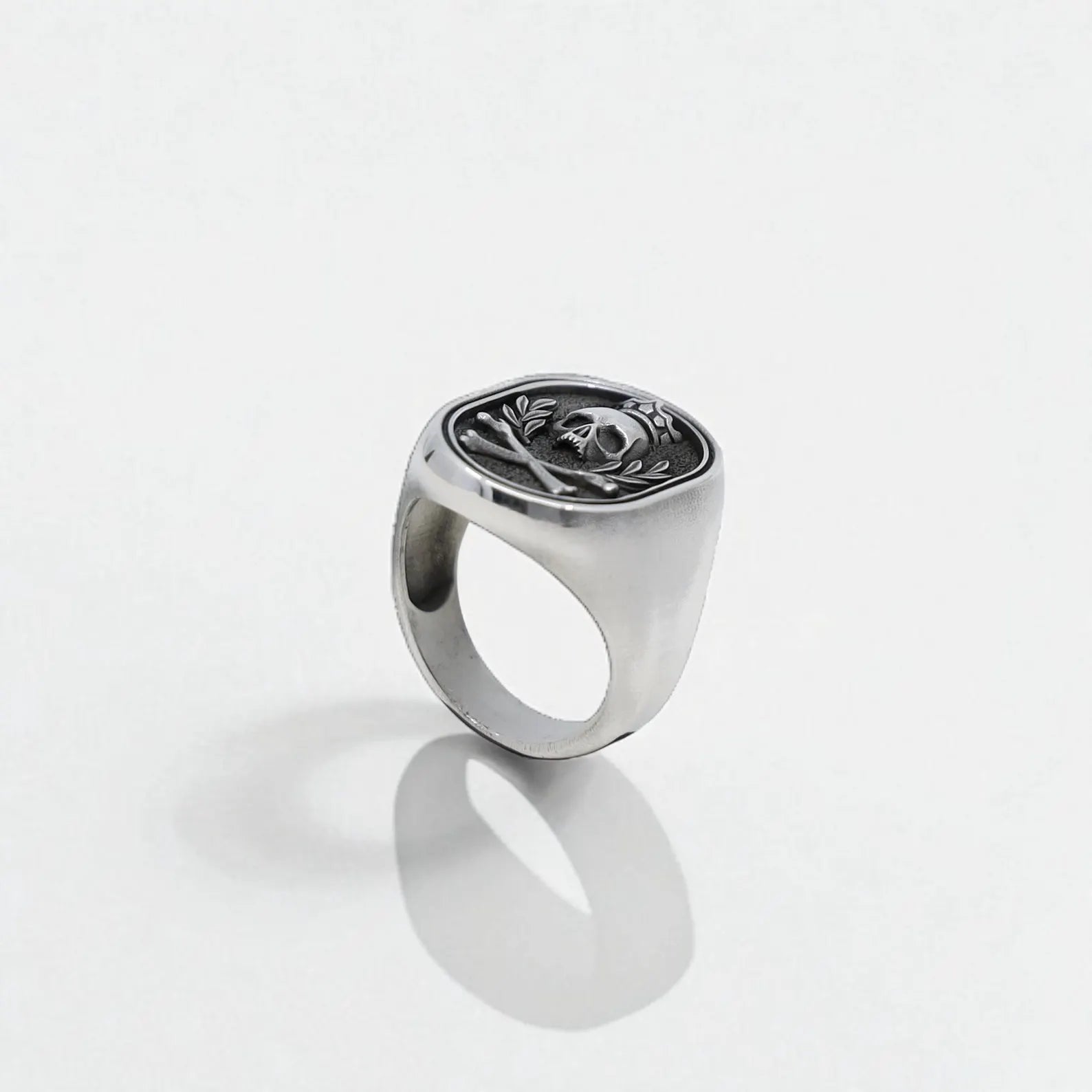 Close-up from the left angle capturing the 3D relief of the crowned skull centerpiece, this ring radiates strength, mystery, and fearless identity. The wide band ensures a masculine profile and comfortable wear for daily use or special events.