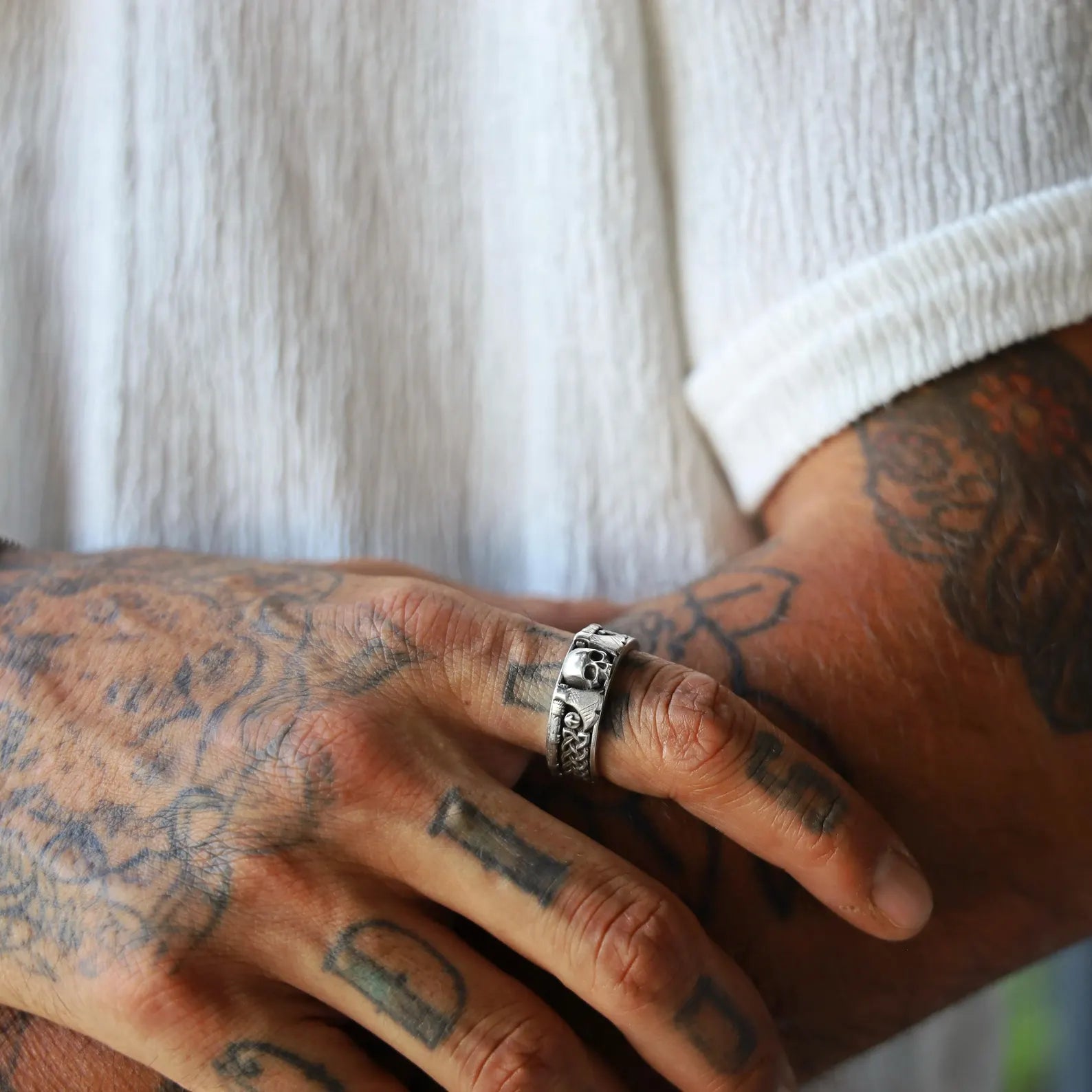 Side angle of a bold silver Viking ring for men, emphasizing the fierce skull emblem and historic knotwork design. This handcrafted piece merges gothic aesthetics with Norse mythology. A statement accessory for daily wear or special events. Perfect birthday or anniversary gift for fans of warrior culture and medieval design.