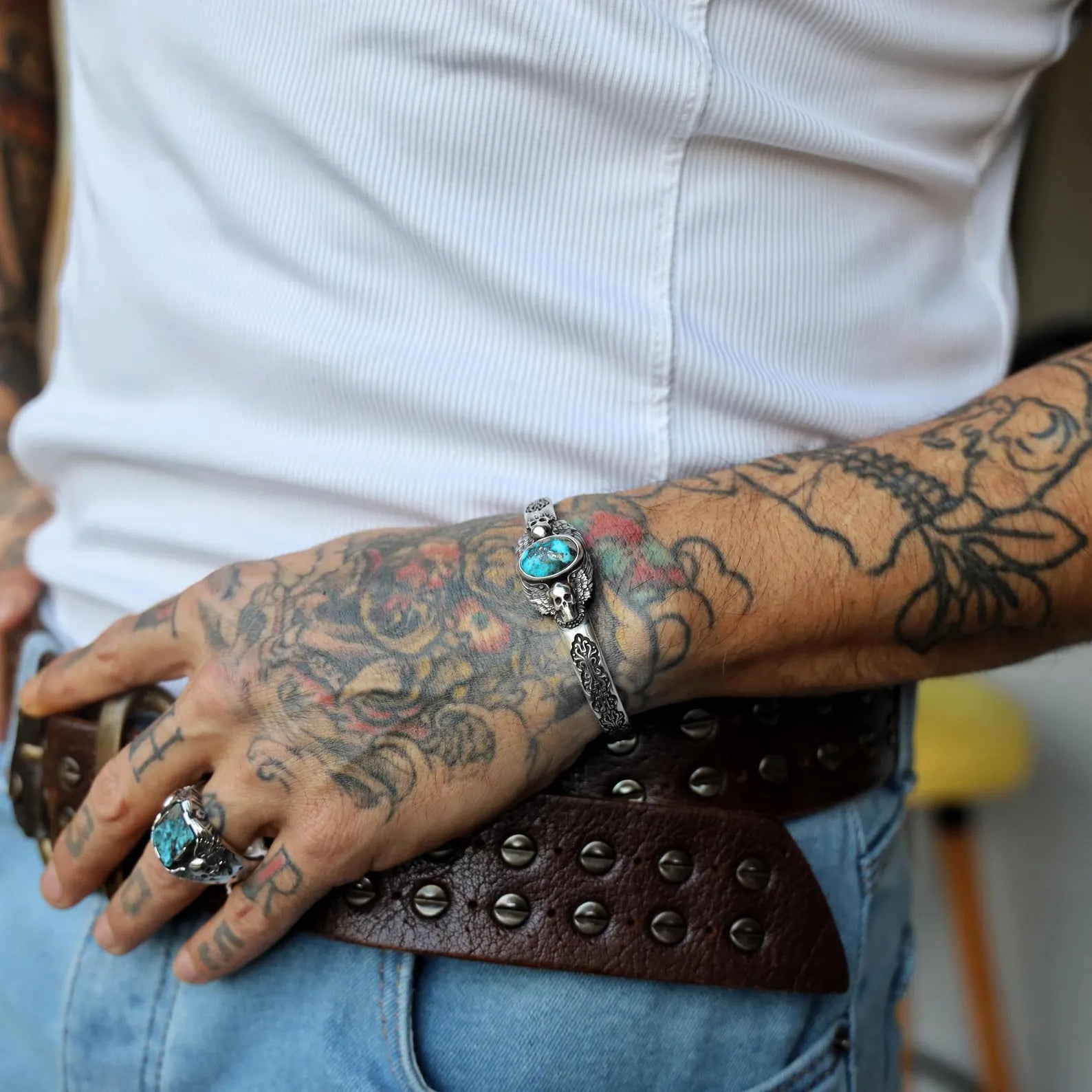 Side profile of this handcrafted silver cuff bracelet for men, showcasing the striking turquoise gemstone centerpiece and detailed gothic skull design. A perfect blend of rugged charm and timeless elegance, this biker-inspired bracelet is a must-have accessory for lovers of Harley Davidson style and those who embrace the spiritual and powerful symbolism of skull jewelry.