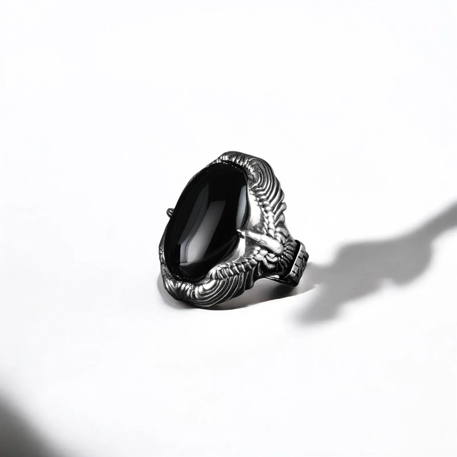 An artisan-made sterling silver ring featuring a large black onyx gemstone surrounded by eagle-inspired gothic detailing, representing vision, courage, and protection. This powerful men’s accessory is an ideal anniversary or birthday gift for someone with a warrior spirit.