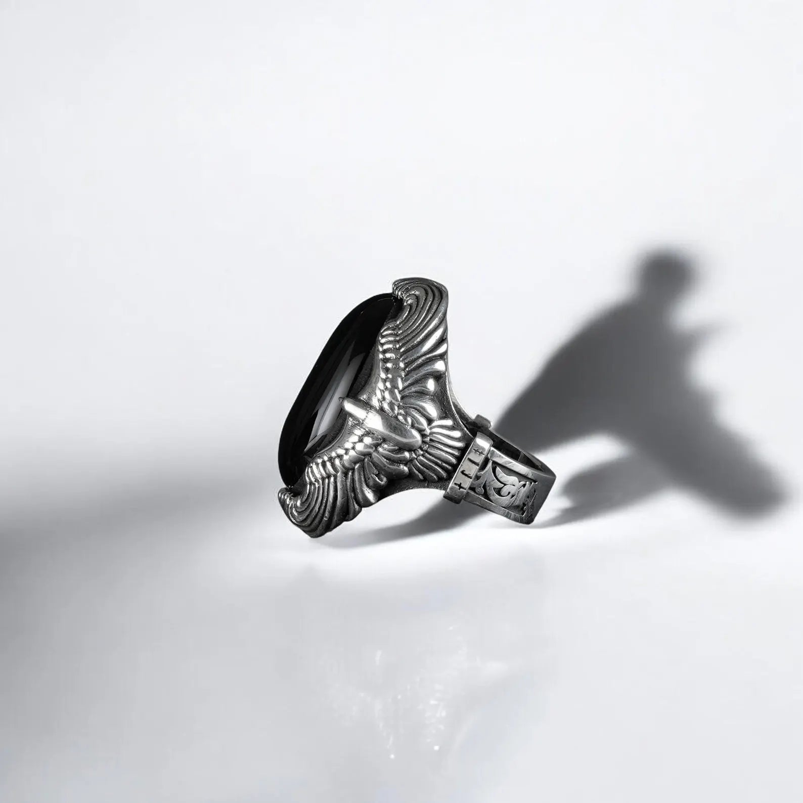This mens statement ring features a polished black onyx centerpiece nested within a gothic eagle claw setting, handcrafted from sterling silver with attention to detail. It’s a timeless piece of symbolic jewelry that celebrates masculine elegance and protective strength.