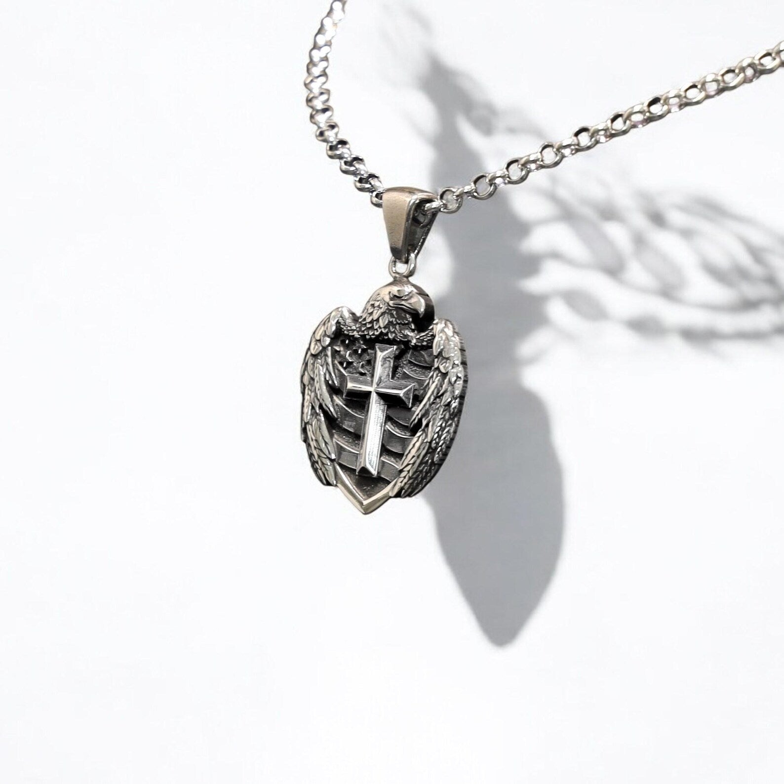 A bold gothic pendant made from 925 sterling silver, combining the iconic American eagle with a classic cross design. This unique necklace reflects both spirituality and national pride, making it an ideal gift for patriotic men on birthdays, graduations, or anniversaries.