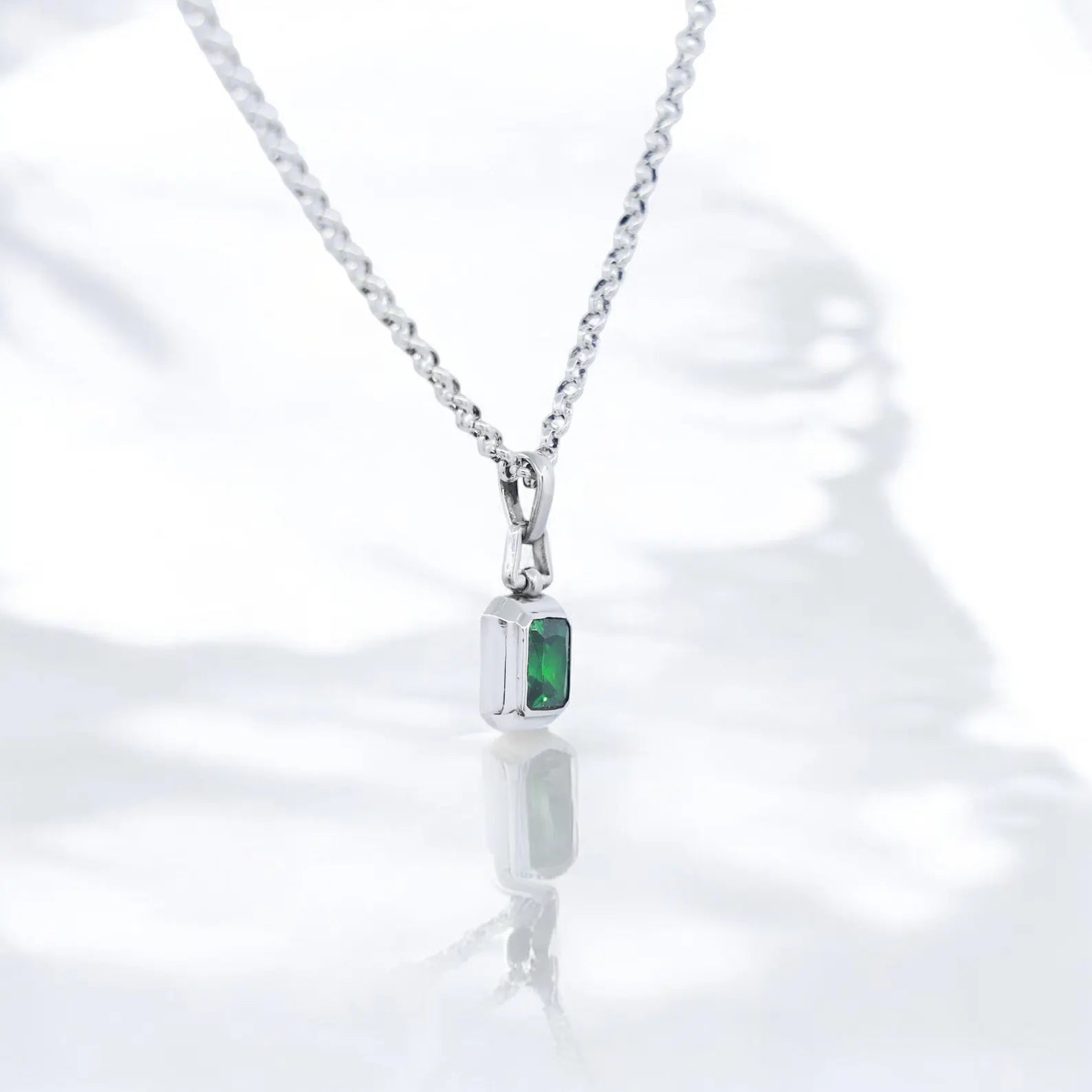 An elegant and bold emerald pendant necklace featuring a high-polish sterling silver setting and a deep green lab-cut gemstone. This luxurious necklace speaks to lovers of gothic, minimalist, or boho aesthetics while offering meaningful symbolism through its color and form. A thoughtful gift option for husbands, boyfriends, or sons who enjoy unique handcrafted silver jewelry with a timeless appeal.
