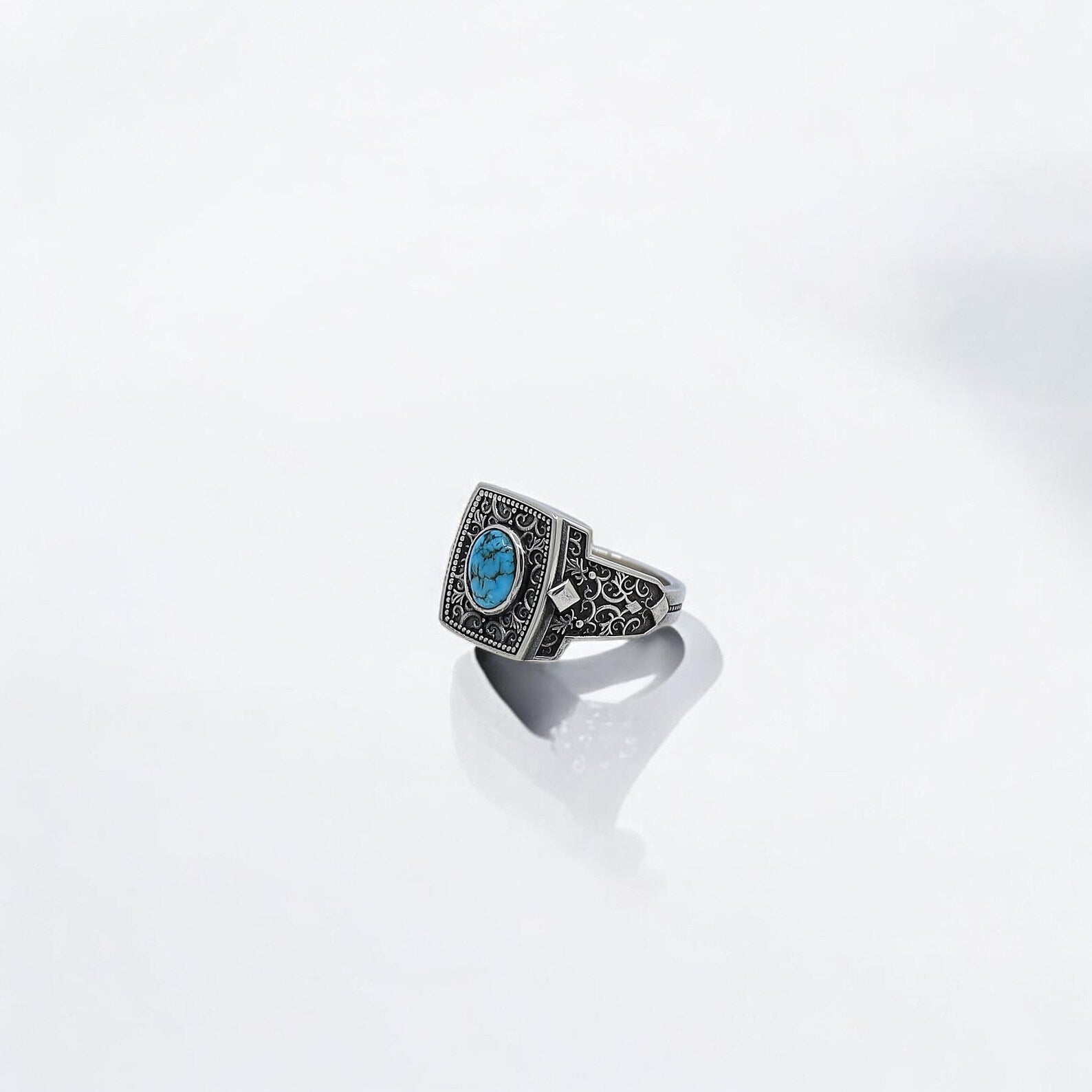 Bold men's turquoise ring with handcrafted scrollwork and vintage western details. A unique jewelry gift for the free-spirited man who values symbolism, tradition, and eye-catching elegance in his accessories.