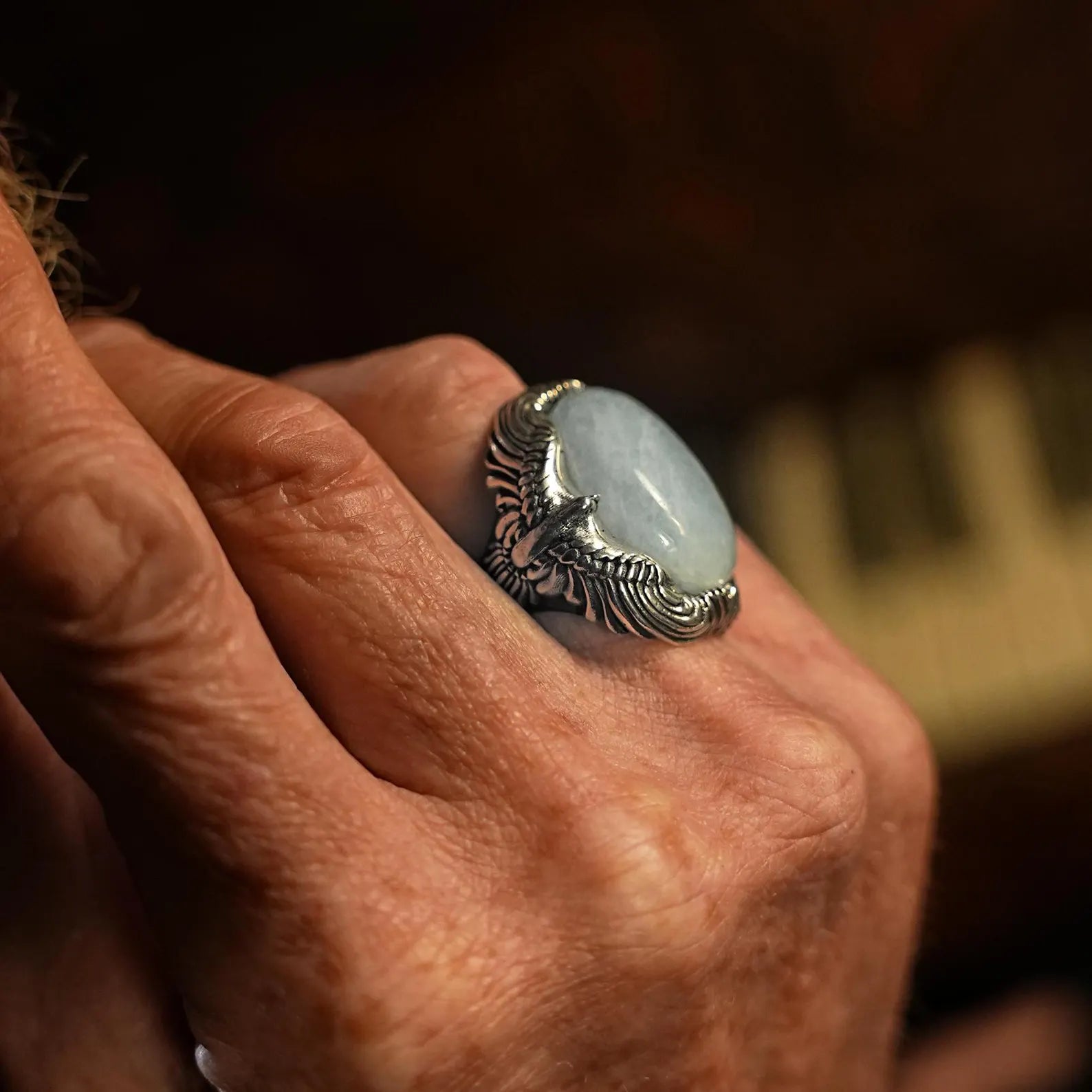 Channel the rugged spirit of biker culture with this sterling silver eagle ring, featuring a calming aquamarine gemstone. The detailed craftsmanship and bold design make it a standout piece for those who appreciate edgy, statement jewelry.