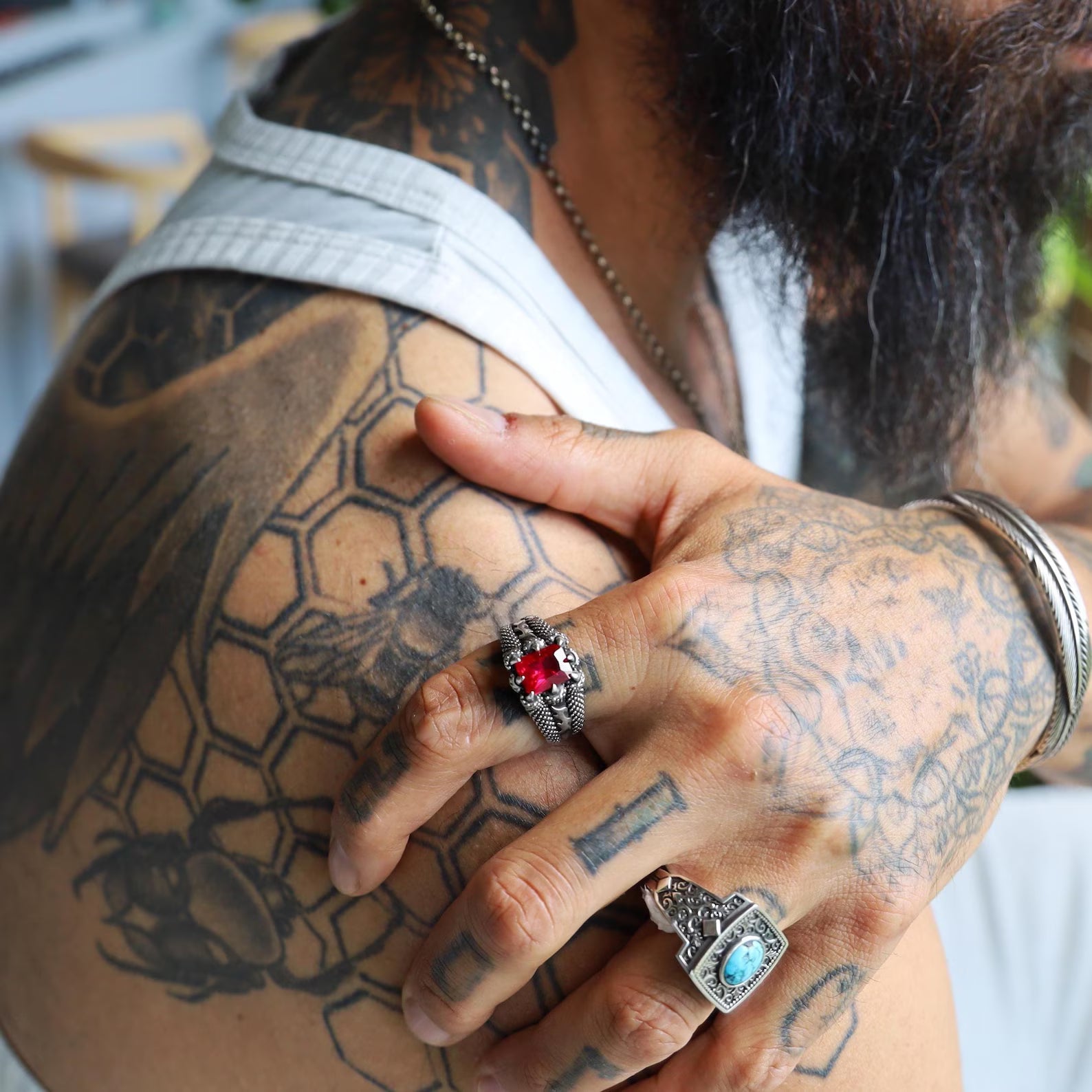 Close-up of the fine craftsmanship of this sterling silver emerald cut ruby ring, revealing the shimmering brilliance of the ruby zircon gemstone. This minimalist ring for men and women combines elegance, sophistication, and a timeless pop of red color that stands out in any jewelry collection.