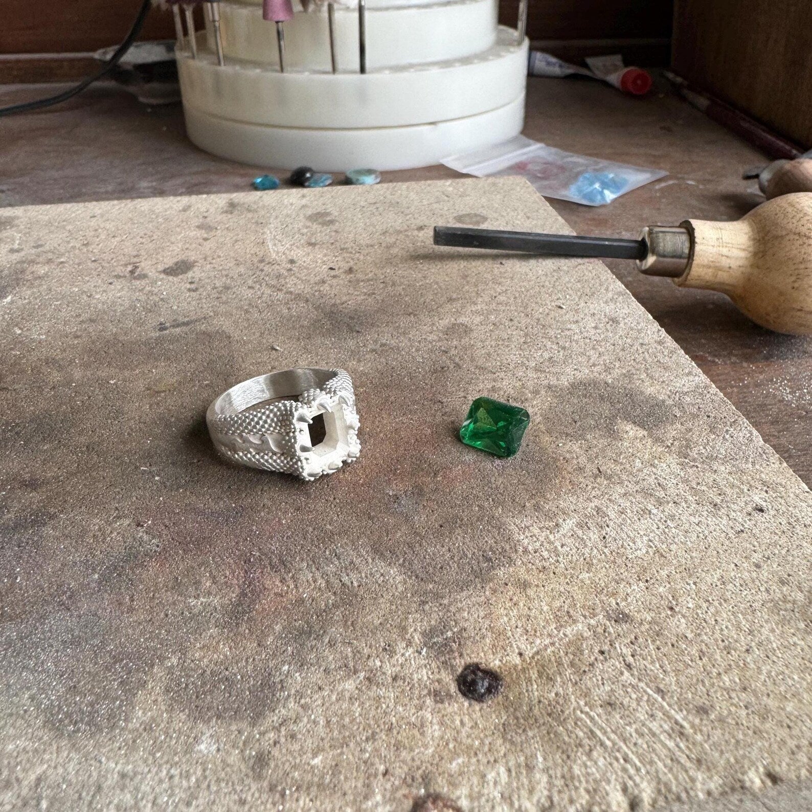 Unique angle of this handcrafted sterling silver emerald cut zircon ring, highlighting the clean lines and elegant green gemstone that make it perfect for everyday sophistication. This birthstone ring for men and women combines sleek minimalist style with the timeless beauty of an emerald cut stone, creating a luxurious and versatile accessory for any occasion.