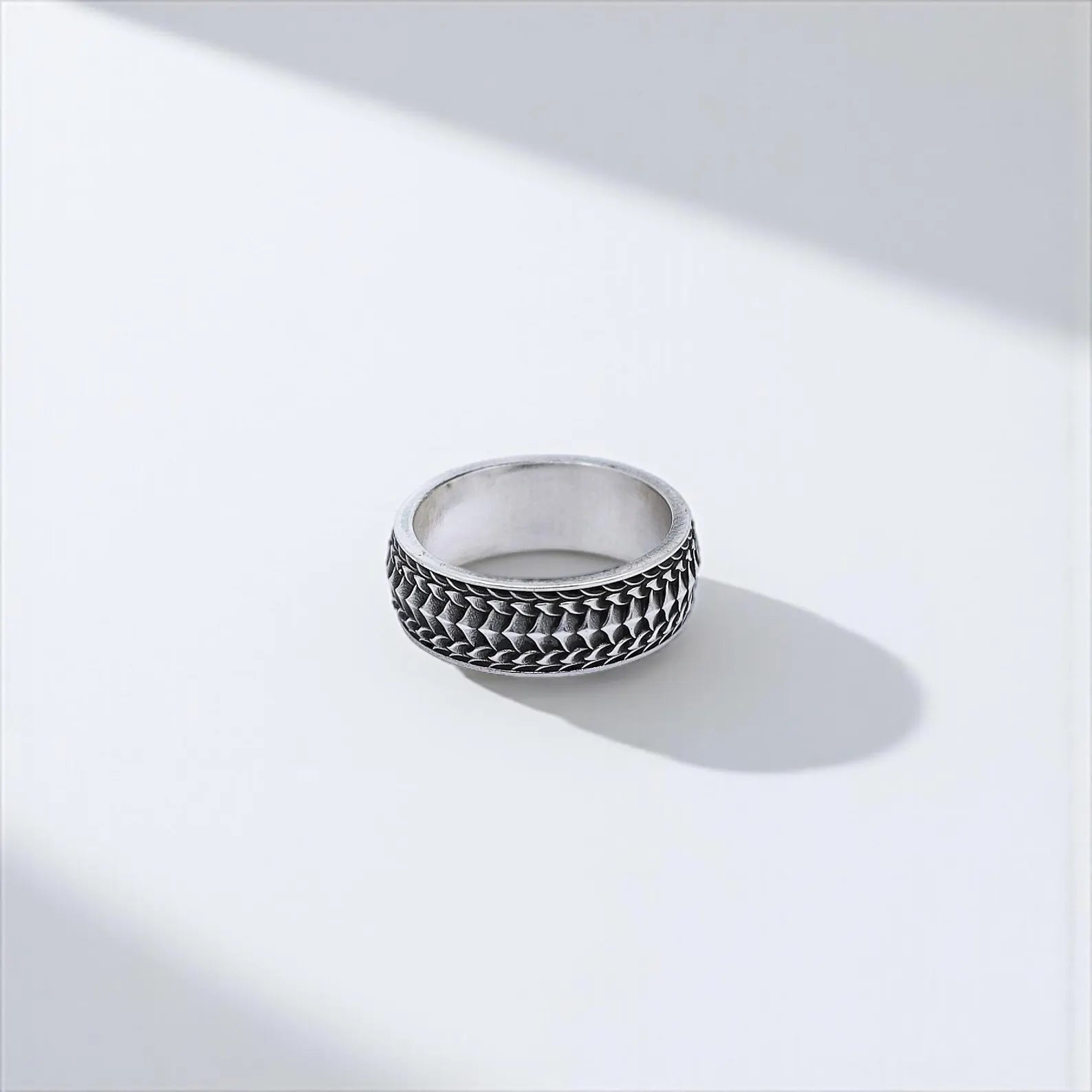 This handcrafted silver band ring features a deep-texture gothic pattern and minimalist shape. Perfect for men seeking a bold yet wearable piece for everyday use or commitment rings. Optimized for Google SEO, Pinterest gothic accessories boards, and Shopify artisan jewelry pages.