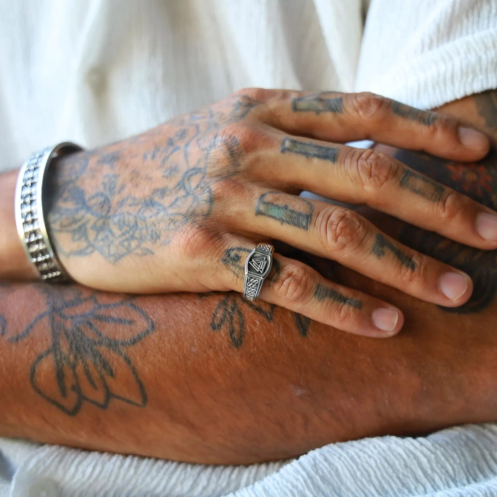 Close-up view of a detailed Norse Valknut pinky ring made from high-quality sterling silver, with handcrafted Celtic knot engravings and oxidized finish for a bold, vintage look — perfect for those who appreciate Viking symbolism and personalized handmade rings.