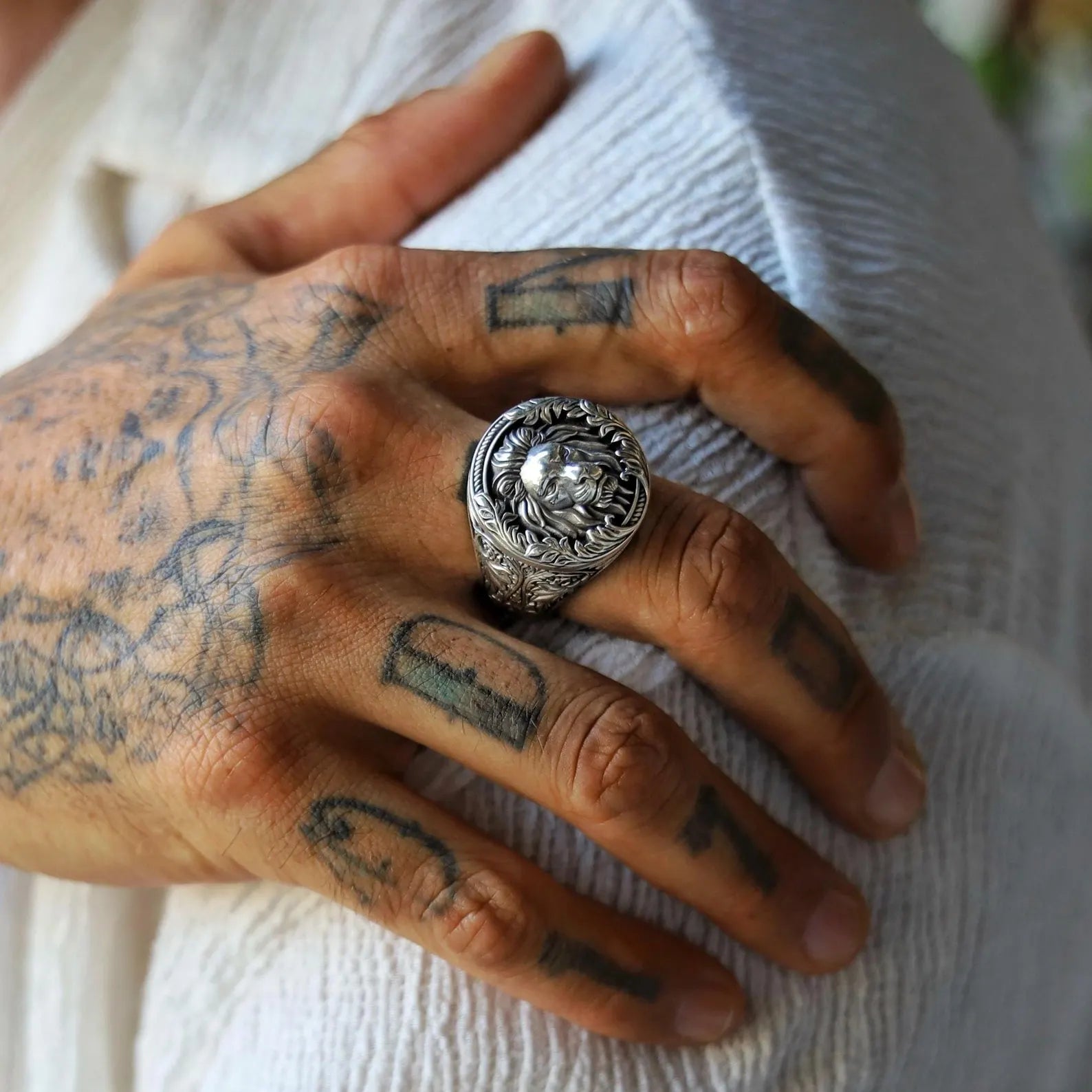Close-up image of a sterling silver royal lion ring for men, featuring a powerful lion head design with a gothic jungle-inspired aesthetic, handcrafted to reflect strength, dominance, and timeless masculine elegance.