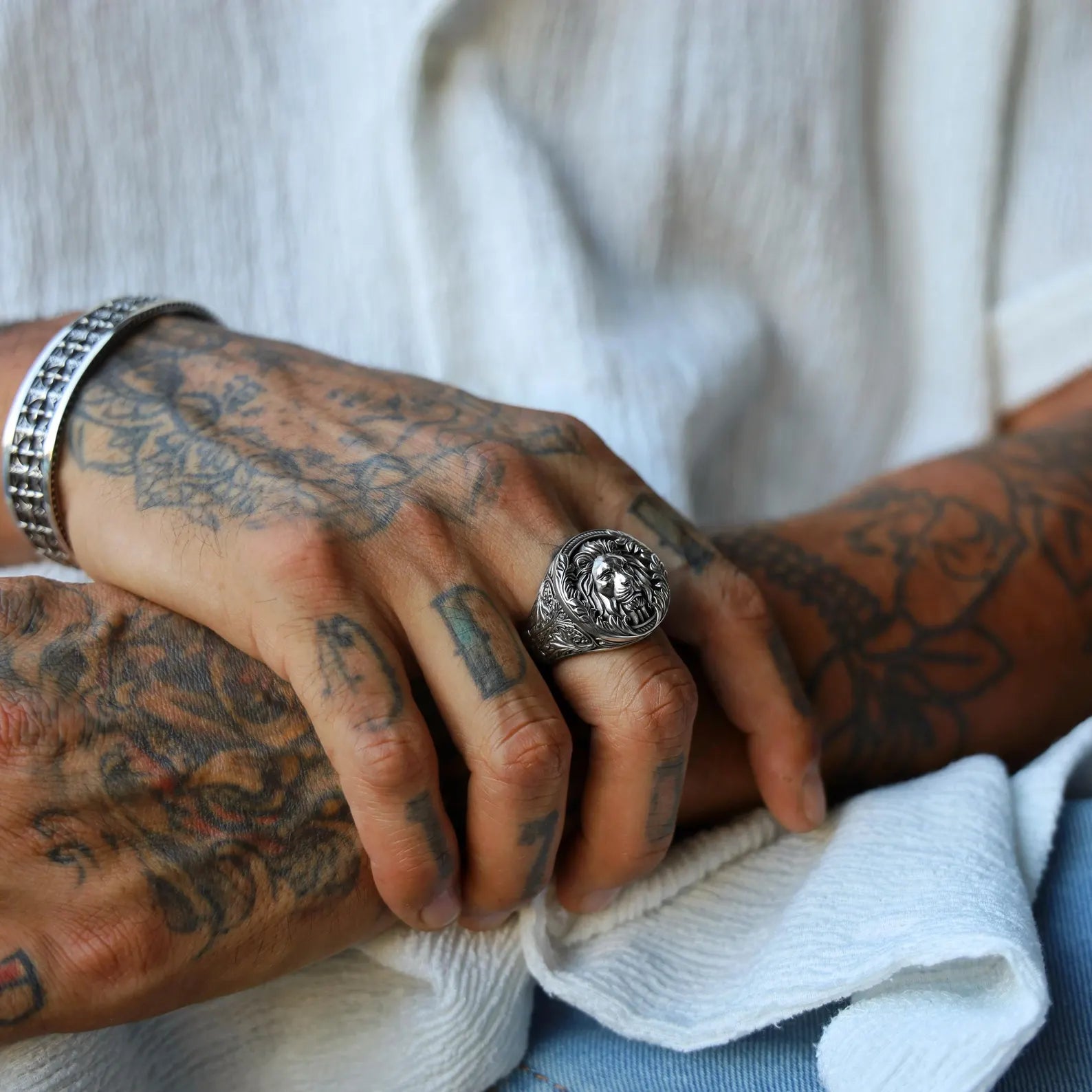 Sterling silver lion head statement ring for men with a gothic design influence, symbolizing courage and leadership, perfect as a unique gift for those who appreciate jungle-themed or mythological jewelry.