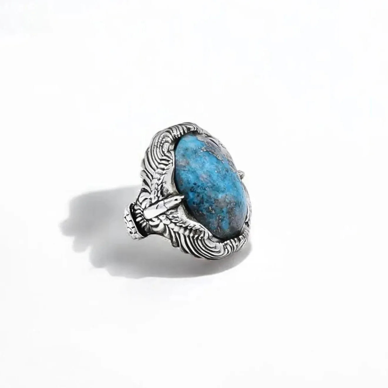 This handcrafted sterling silver turquoise ring showcases bold Western elegance with intricate Native American-inspired detailing. Made from solid 925 silver and weighing 27 grams, the ring features a natural blue turquoise stone that symbolizes strength and protection. A unique and powerful accessory for men who embrace cowboy culture and spiritual symbolism.