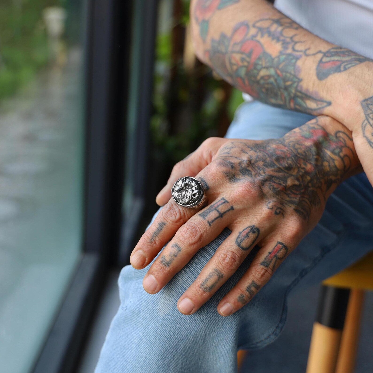 Elegant silver ring for men featuring a mirrored wolf design in a circular frame, portraying harmony in opposing forces. A perfect combination of Norse mythology influence and modern masculinity.