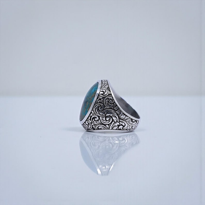 Bold masculine signet ring for men featuring a large turquoise gemstone set in a Baroque engraved sterling silver frame