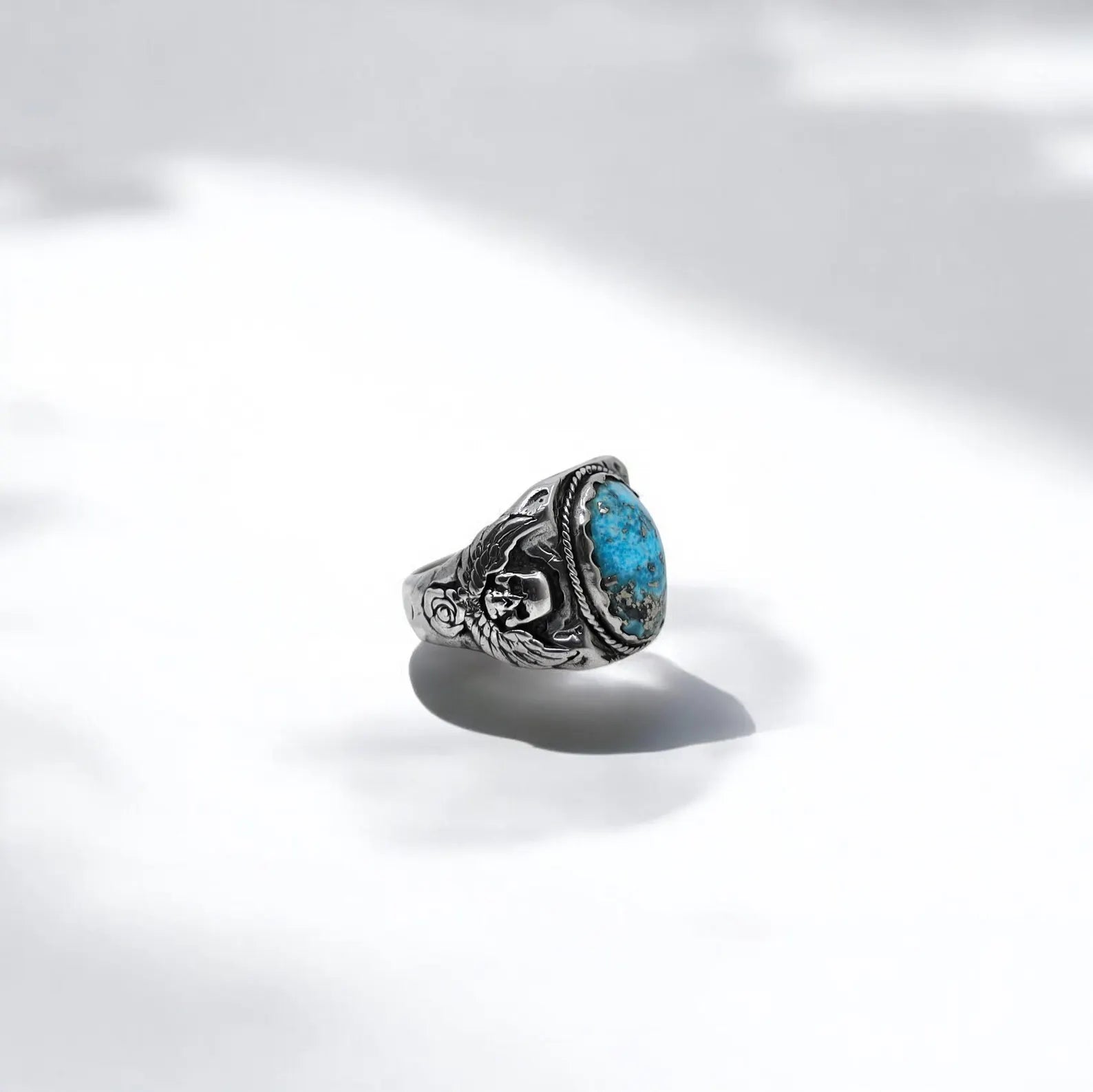 Gothic skull ring for men featuring an oval turquoise gemstone and handcrafted texture. This biker-inspired piece merges vintage western aesthetics with a modern warrior spirit, perfect for statement wear.