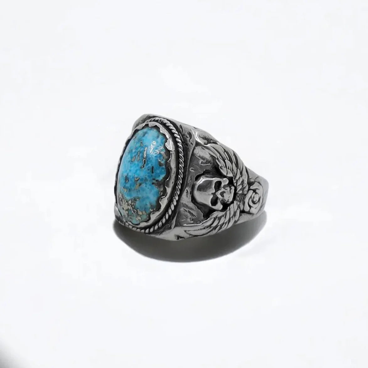 Unique turquoise biker ring for men handcrafted from solid 925K silver, showcasing a powerful skull motif on both sides. This ring is a perfect gift for motorcycle lovers, free spirits, and those who resonate with gothic and western design.