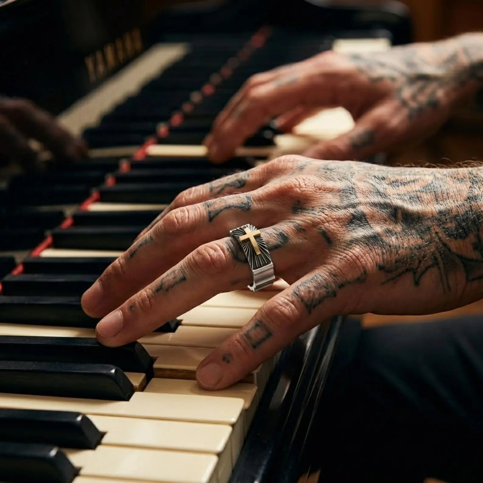 Close-up view of a unique silver wedding band ring showcasing a gold cross symbol, designed as meaningful Christian jewelry for men