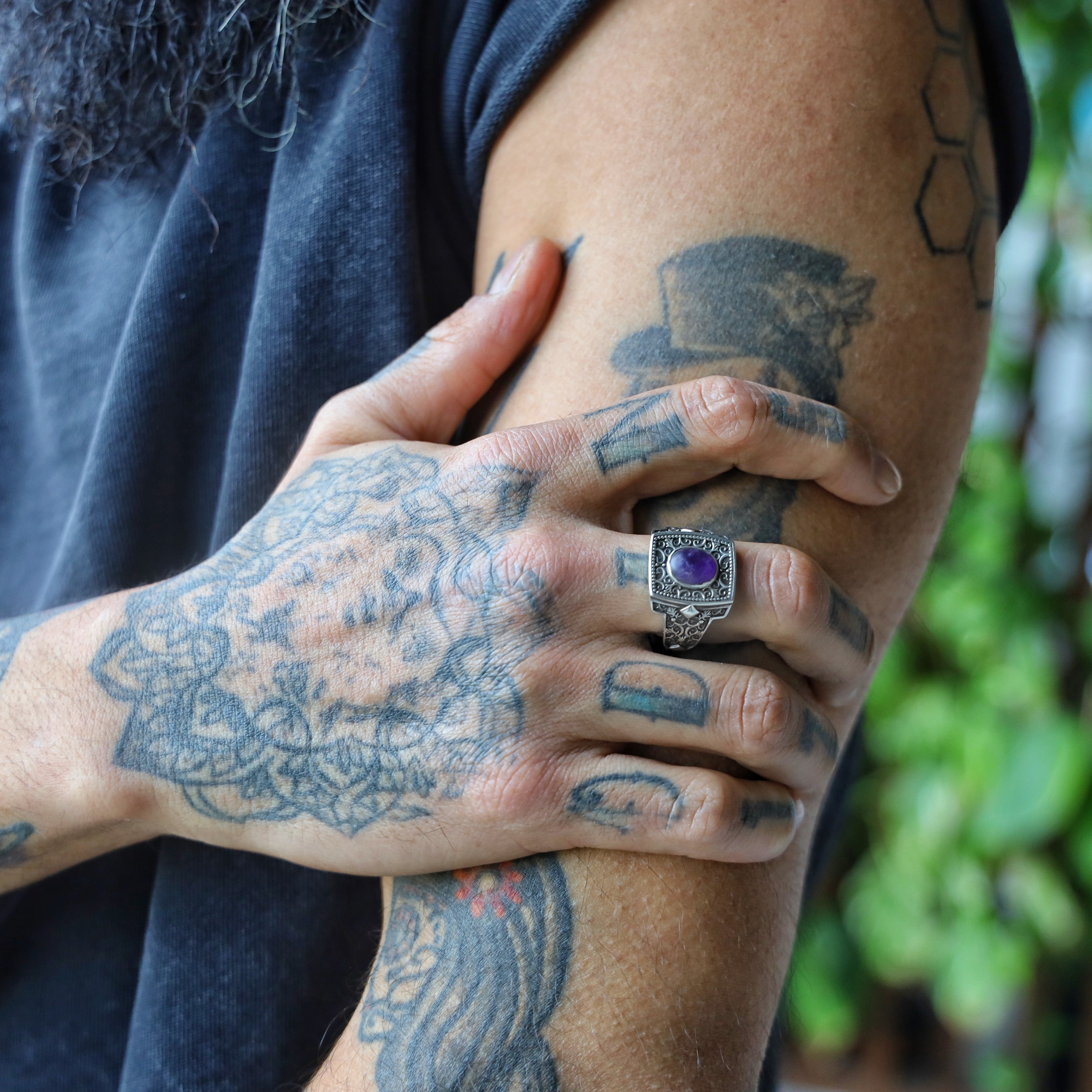 This stunning men’s statement ring is crafted from 925K sterling silver and set with a genuine oval amethyst, framed by ornate vintage engravings. The handcrafted details reflect a fusion of gothic and bohemian aesthetics, making this piece ideal for artistic souls and lovers of antique-style jewelry. Personalize it with a name or date for an unforgettable keepsake that blends elegance and emotional meaning.