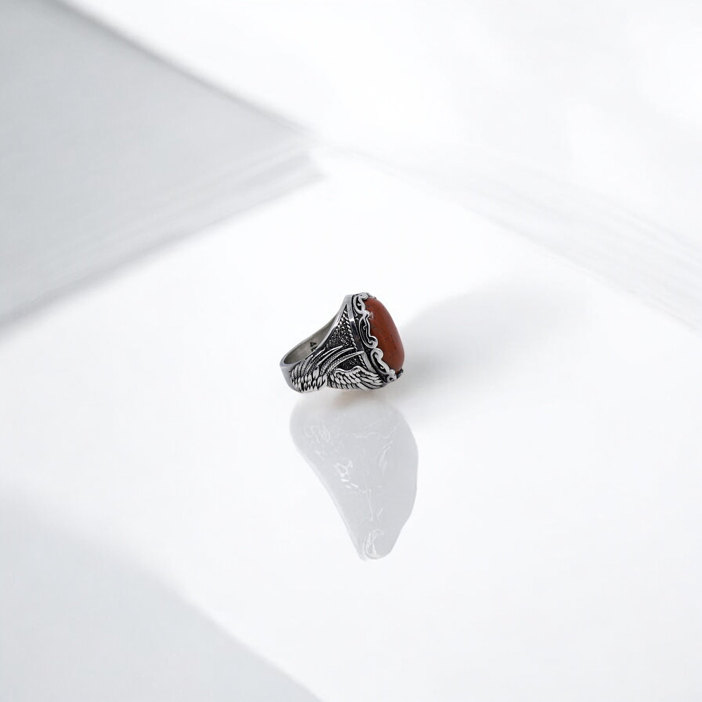 This sterling silver men’s ring showcases a powerful fusion of gothic and tribal artistry with a centerpiece made of polished red jasper. The gemstone’s warm, earthy tone enhances the mystique of the engraved patterns surrounding it, offering a masculine yet mystical appeal. Designed for those who seek more than just a ring — this is a piece of wearable art, ideal for bohemian men, spiritual individuals, or anyone who desires jewelry with soul and significance.