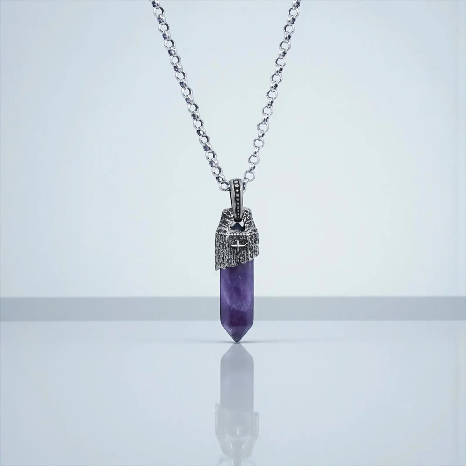 Close-up shot of a handcrafted sterling silver amethyst pendant necklace for men, featuring a natural purple amethyst gemstone set in a vintage-inspired nautical design with oxidized details, hanging on a 925 sterling silver chain.