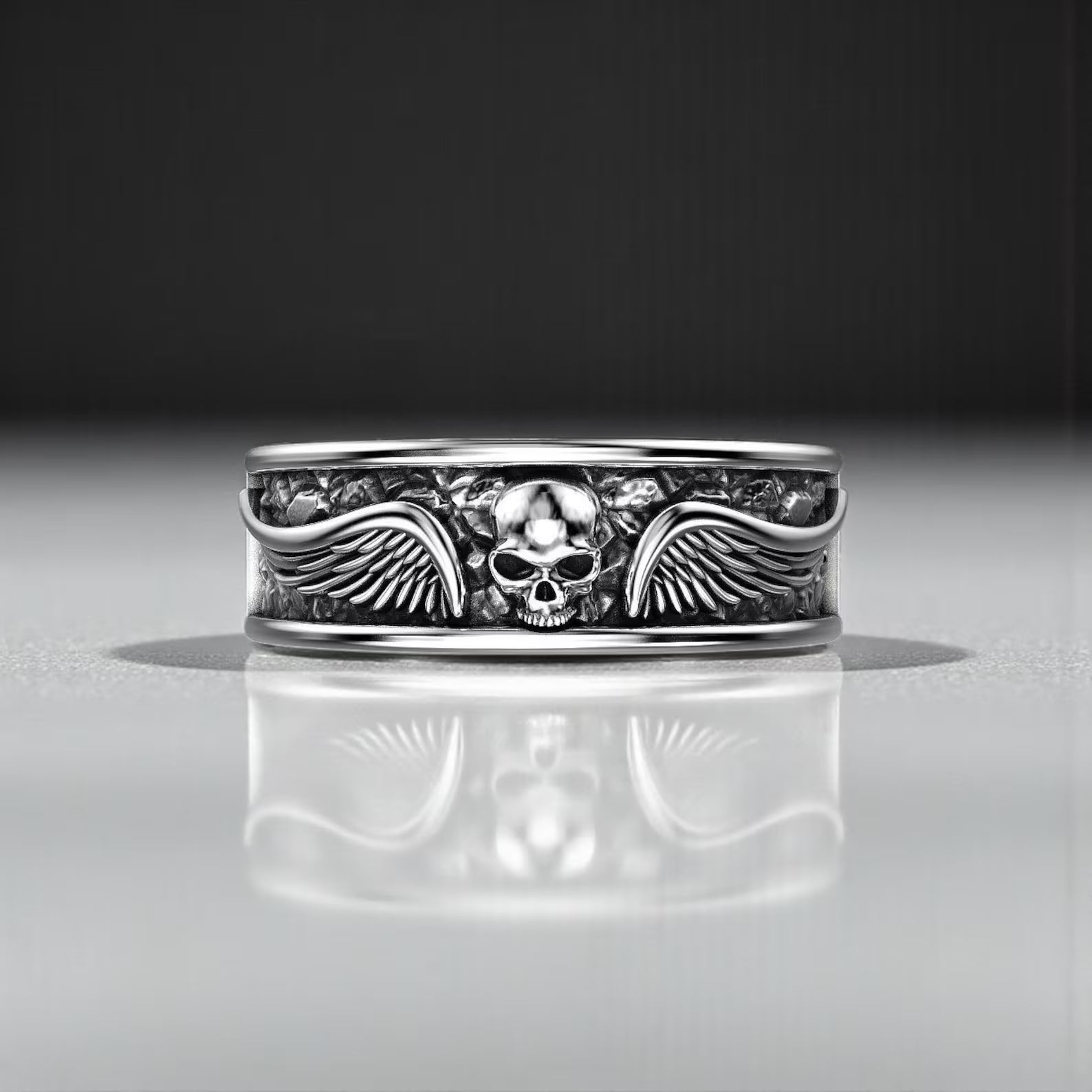 Macro shot of a gothic winged skull ring made from nickel-free 925 silver, emphasizing the intricate engravings, durable craftsmanship, and bold aesthetic for men who appreciate distinctive biker jewelry.