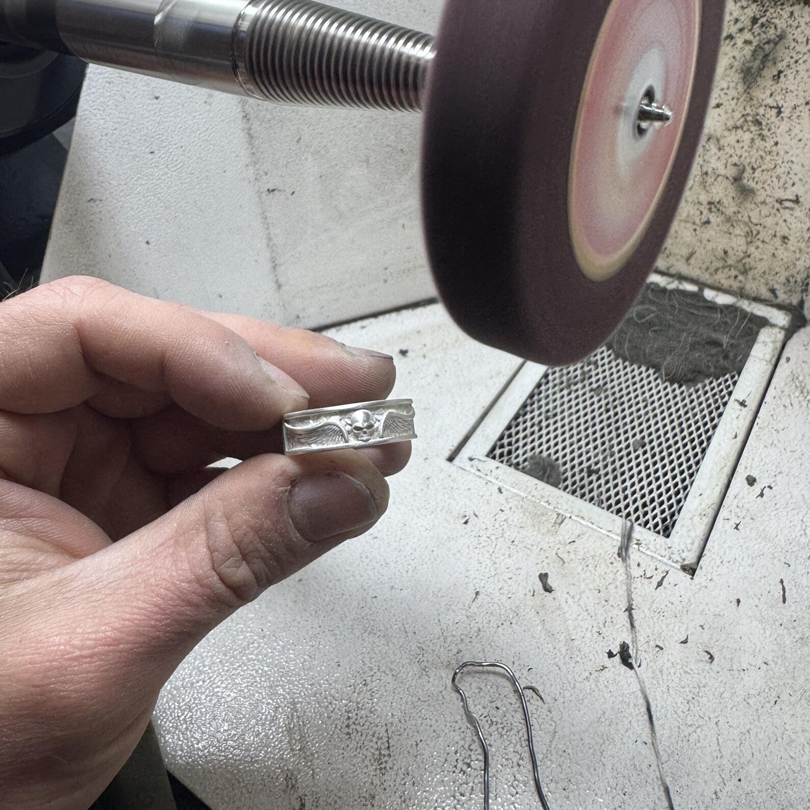 Solid sterling silver skull band ring created entirely by hand, featuring detailed skull motifs and handcrafted textures, crafted as a durable and masculine handmade silver ring.